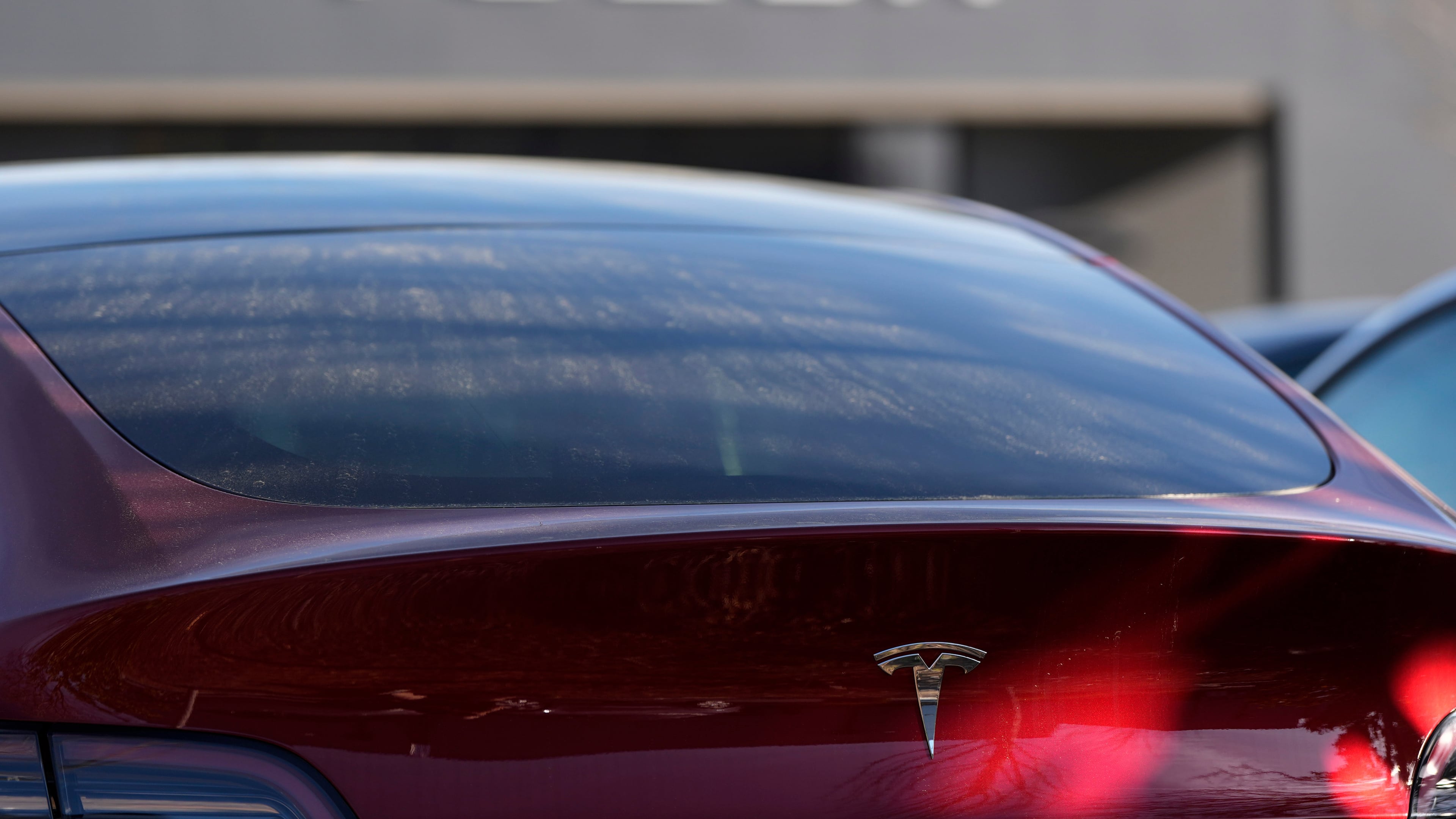 FILE - A Tesla model Y and other Telsla vehicles sit at a dealership, Wednesday, March 19, 2025, in Kennesaw, Ga. (AP Photo/Mike Stewart, File)