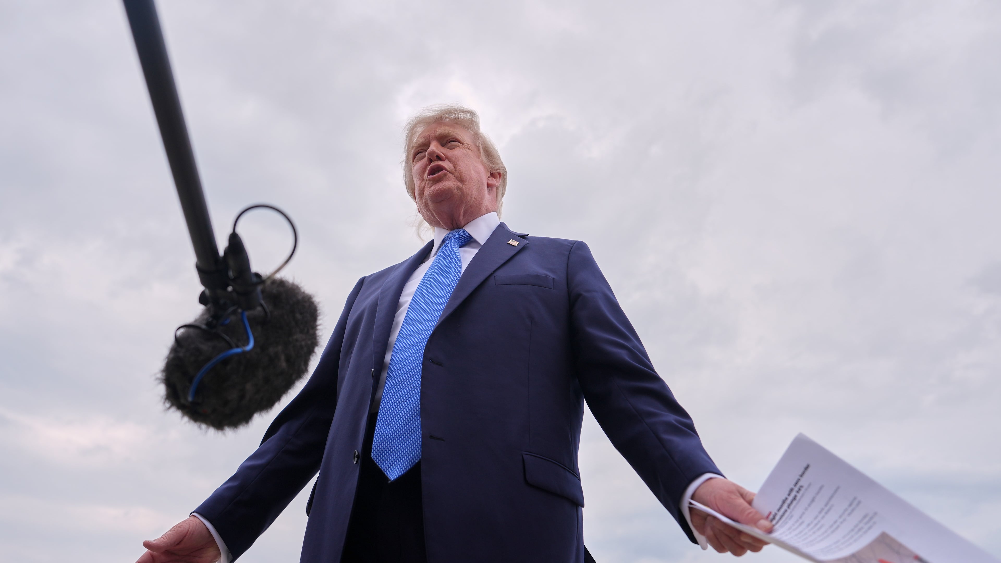 President Donald Trump speaks with reporters before boarding Air Force One, Friday, Aug. 14, 2026, at Joint Base Andrews, Md. (AP Photo/Julia Demaree Nikhinson)