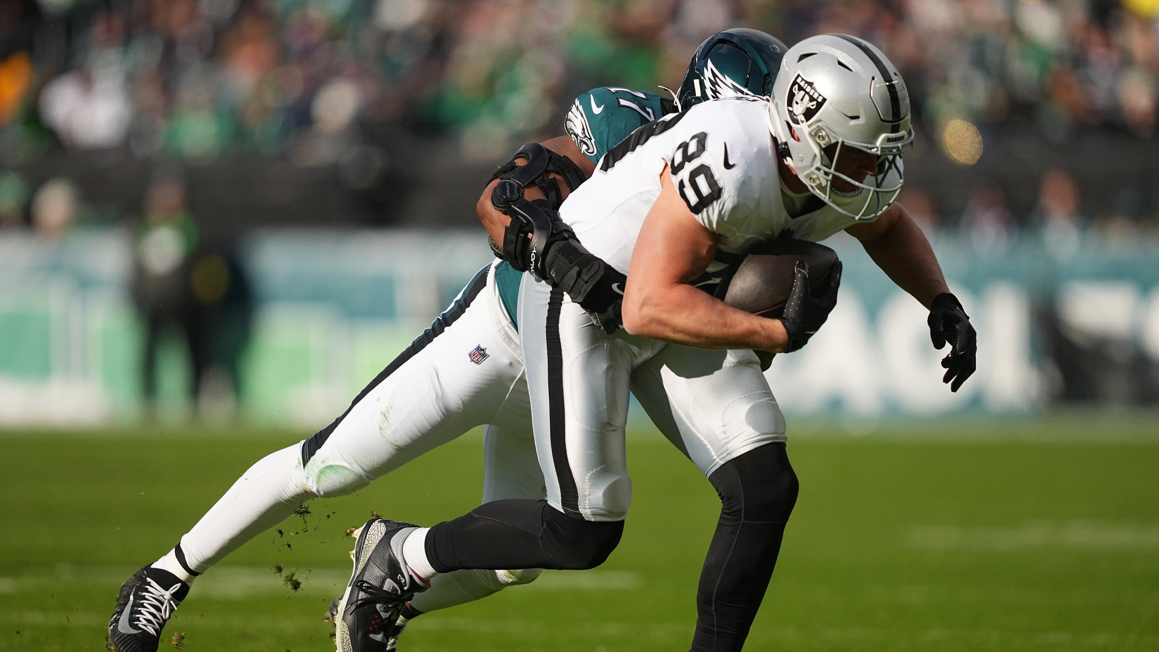 Raiders tight end Brock Bowers (front) is brought down by then-Eagles linebacker Nakobe Dean. Dean was traded from Philadelphia to Las Vegas and will be Bowers’ teammate this season. (Matt Rourke/AP 2025)