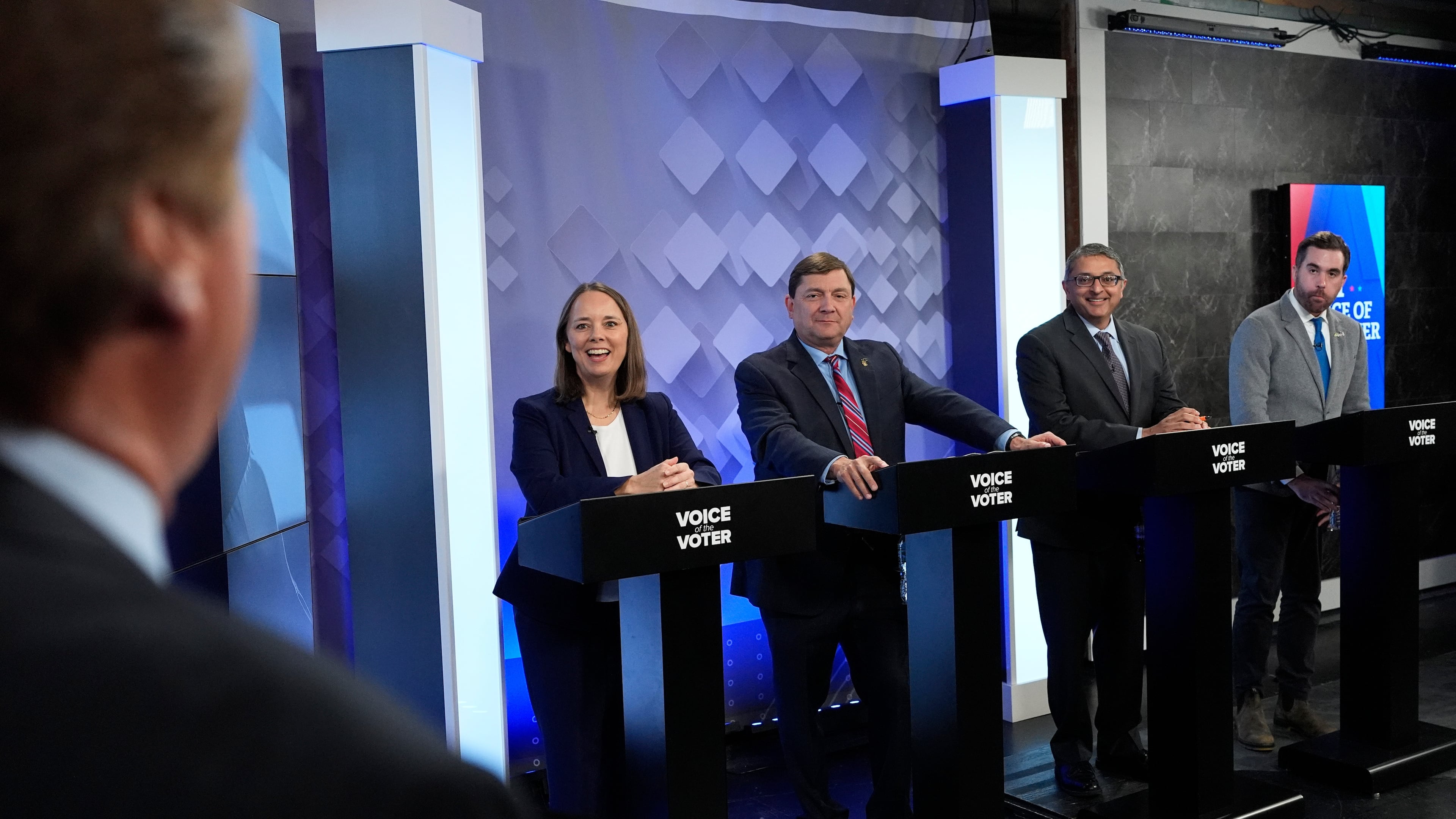 From podium left, U.S. Senate candidates Shenna Bellows, Troy Jackson, Dr. Nirav Shah, and Jordan Wood talk with moderator Phil Hirschkorn at WCSH-6 before a televised debate at the WCSH-6 studio Thursday, July 16, 2026, in Portland, Maine. (AP Photo/Robert F. Bukaty)