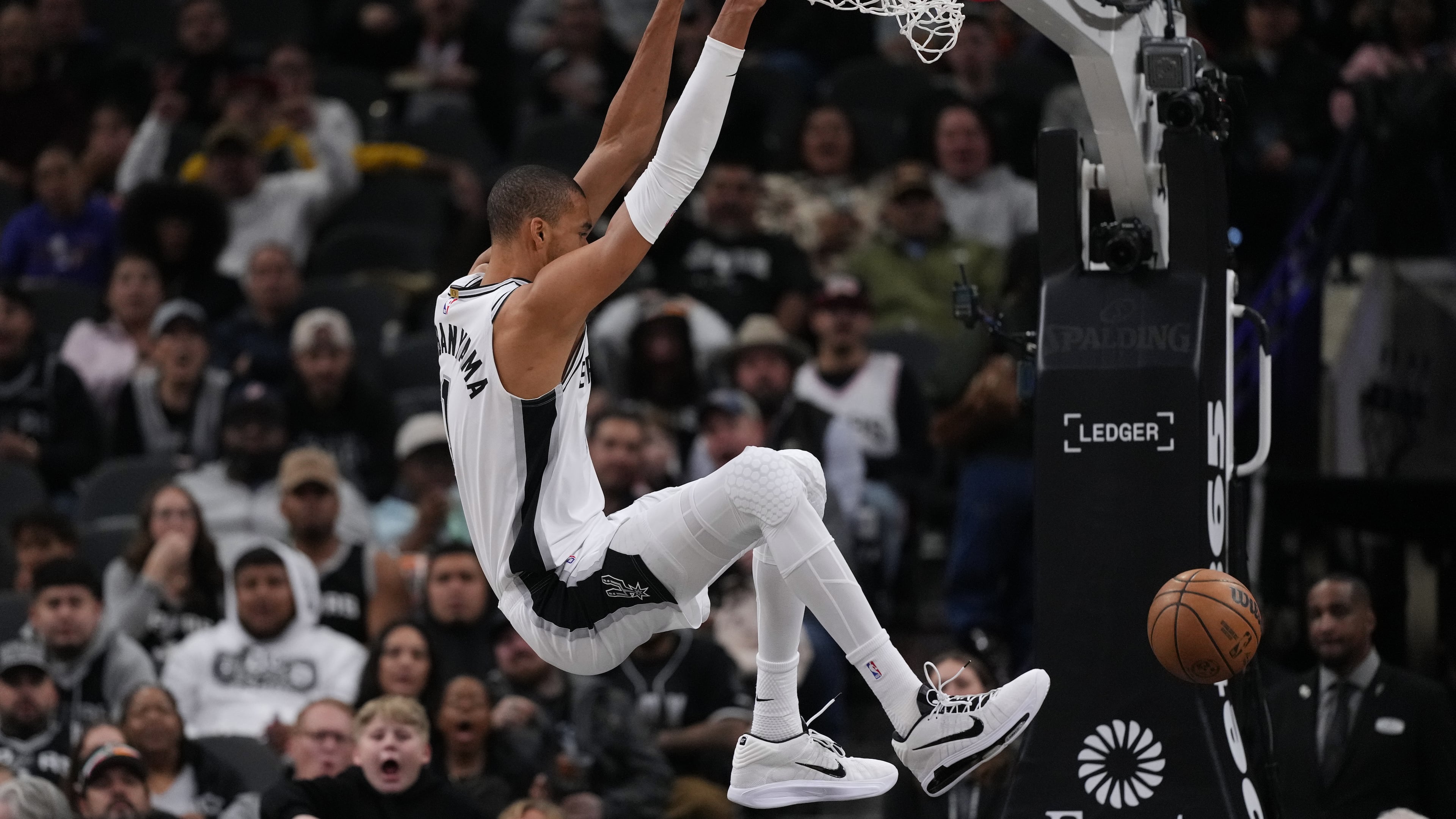 San Antonio Spurs forward Victor Wembanyama (1) scores against the Orlando Magic during the first half of an NBA basketball game in San Antonio, Sunday, Feb. 1, 2026. (AP Photo/Eric Gay)