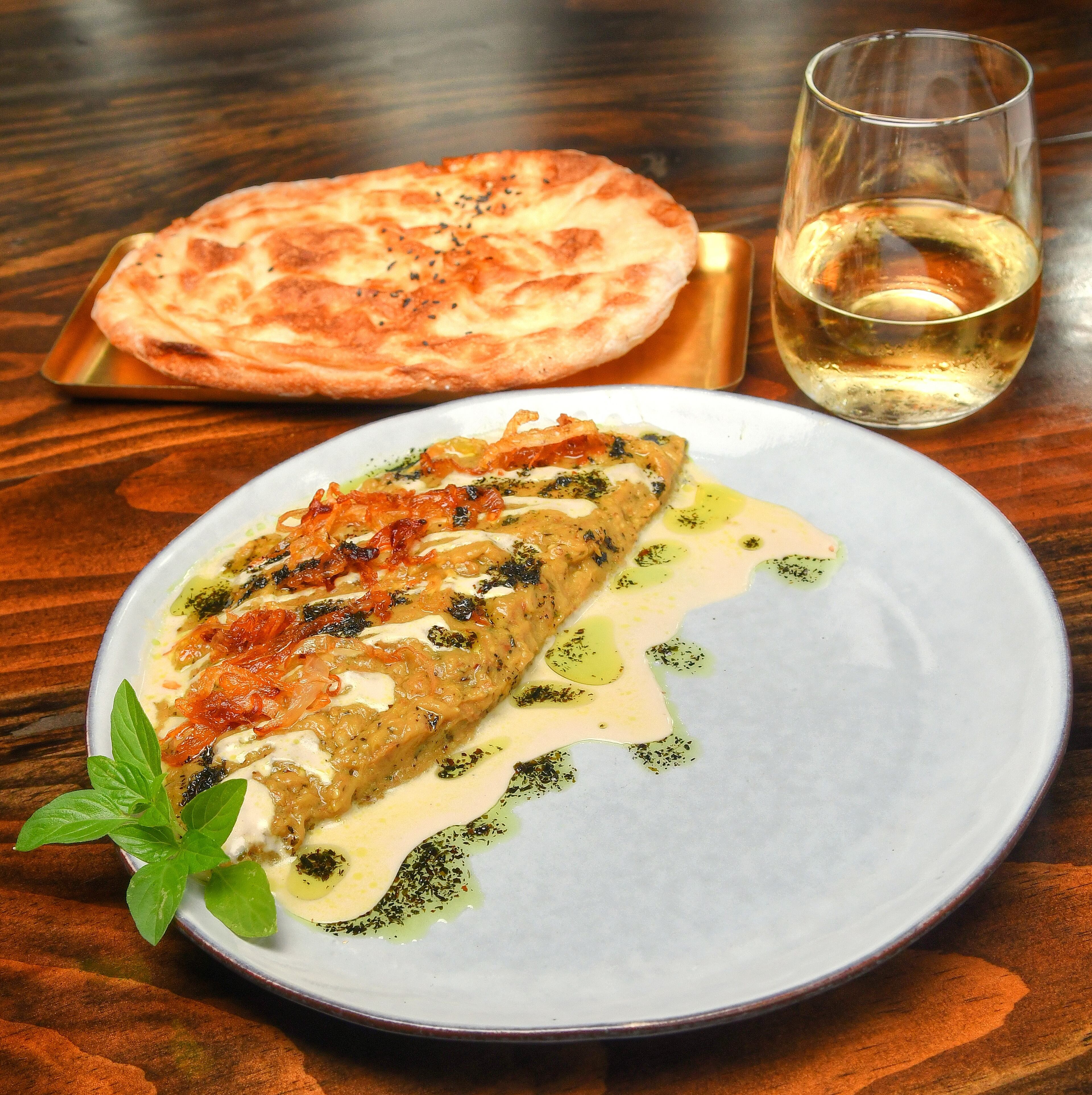 Kashke Bademjaan (Roasted Eggplant) differs from baba ghanoush with the way it’s prepared and the addition of mint to the eggplant. Styling by executive chef Ermiya Rezai. Chris Hunt/FOR THE AJC