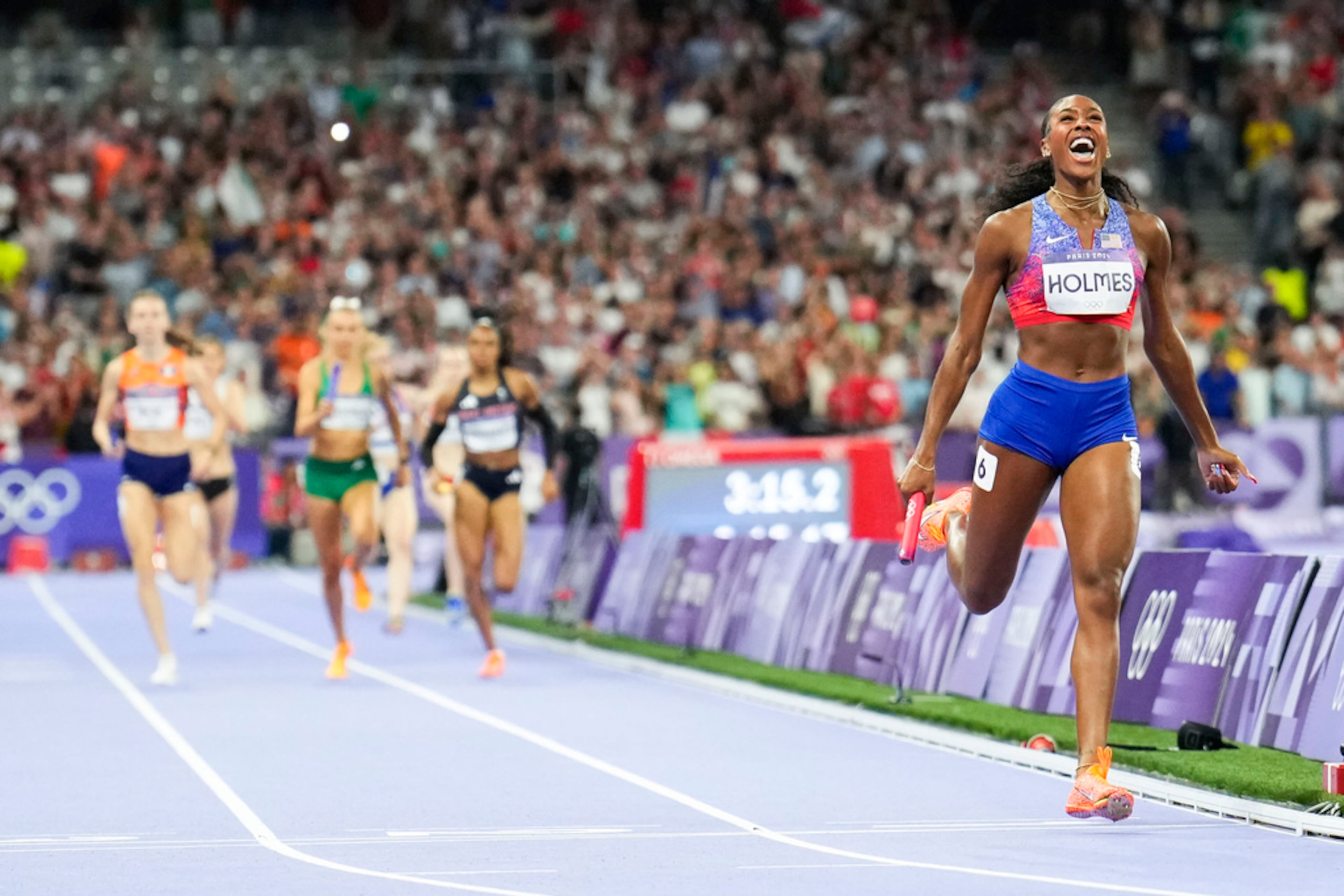 Alexis Holmes, of the United States, celebrates after winning the women's 4 x 400-meter relay final at the 2024 Summer Olympics, Saturday, Aug. 10, 2024, in Saint-Denis, France. (AP Photo/Petr David Josek)