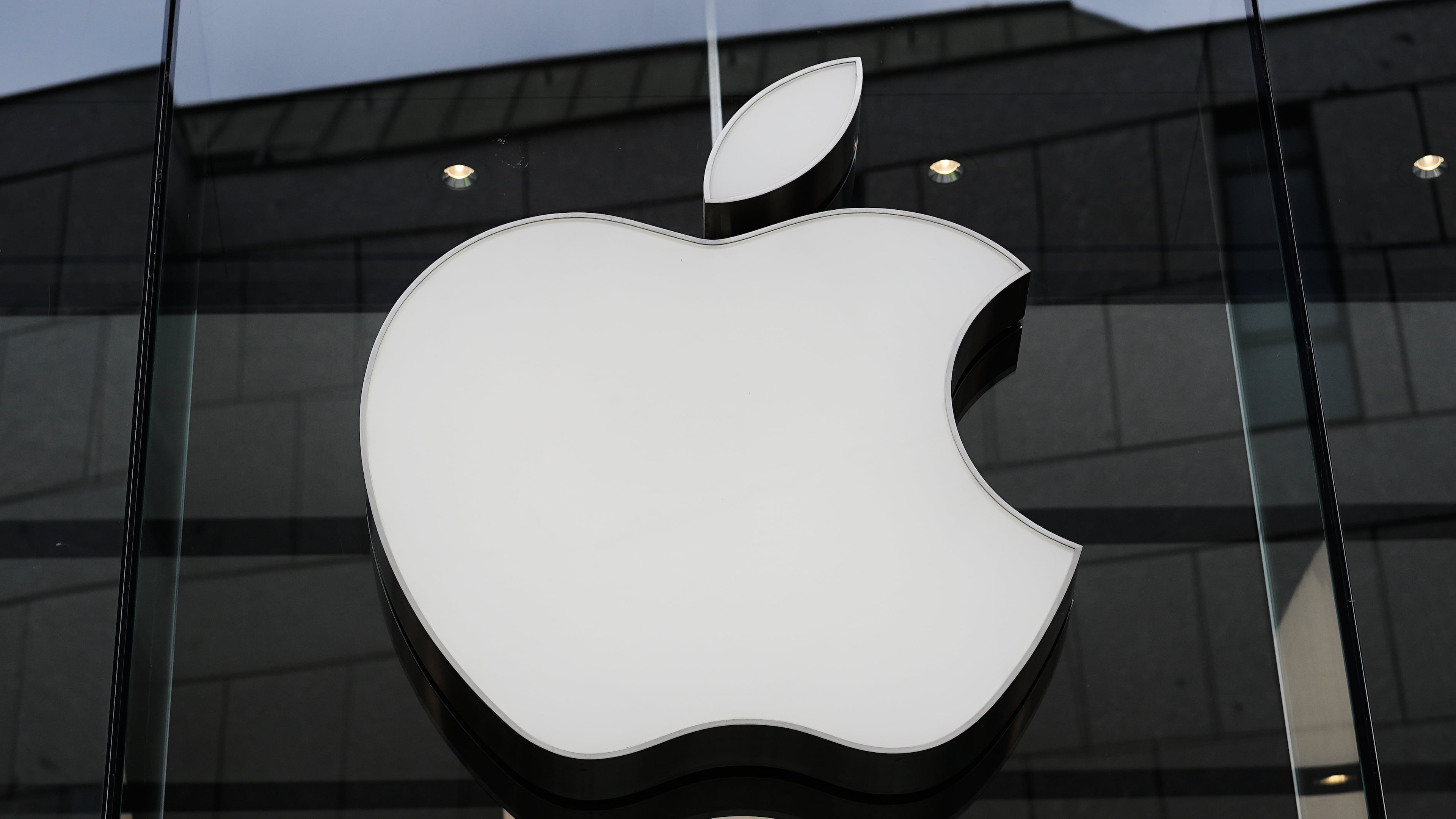 FILE - The Apple logo is illuminated at a store in Munich, Germany, April 2, 2026. (AP Photo/Matthias Schrader, File)