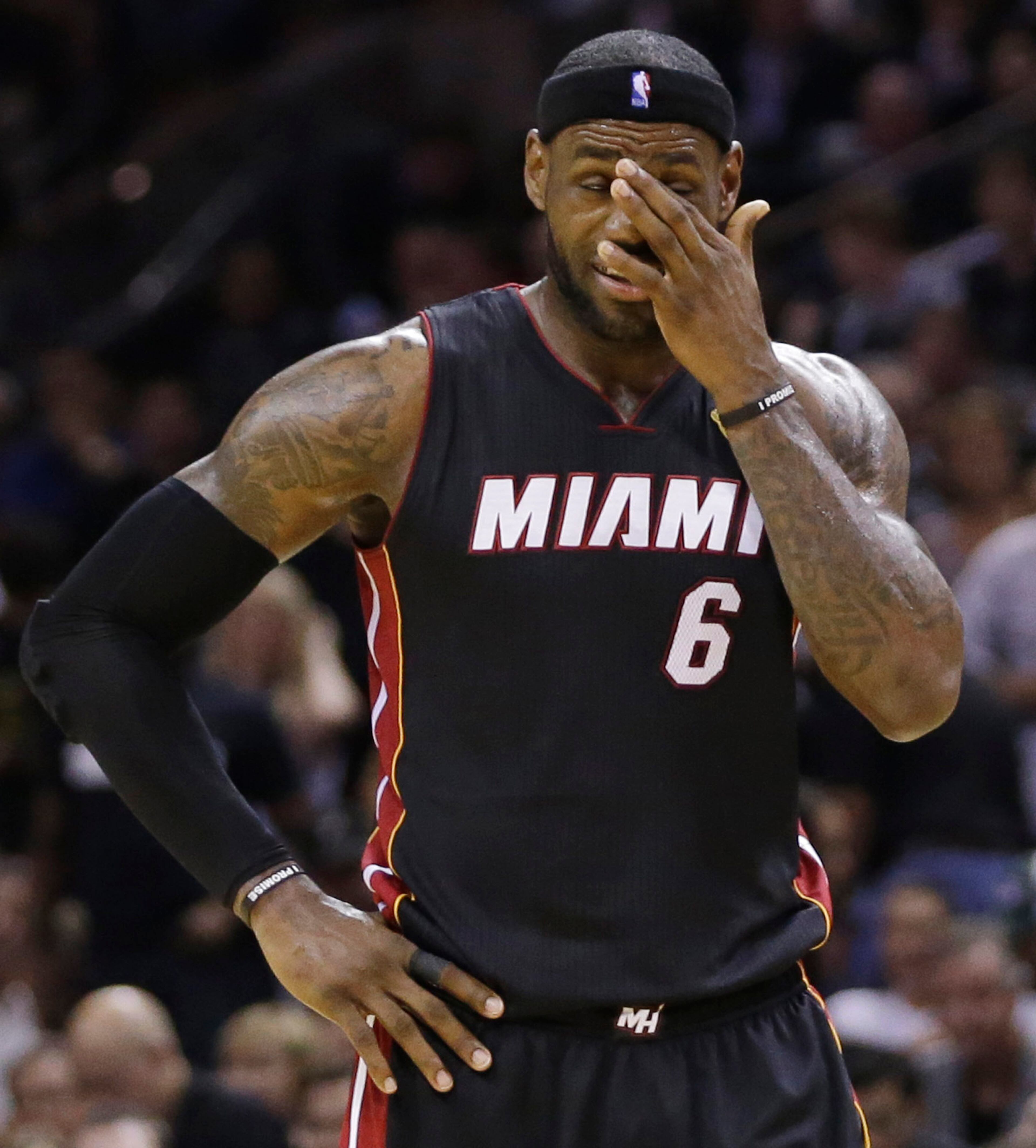 Miami Heat forward LeBron James (6) pauses between plays against the San Antonio Spurs during the second half in Game 5 of the NBA basketball finals on Sunday, June 15, 2014, in San Antonio. (AP Photo/David J. Phillip)