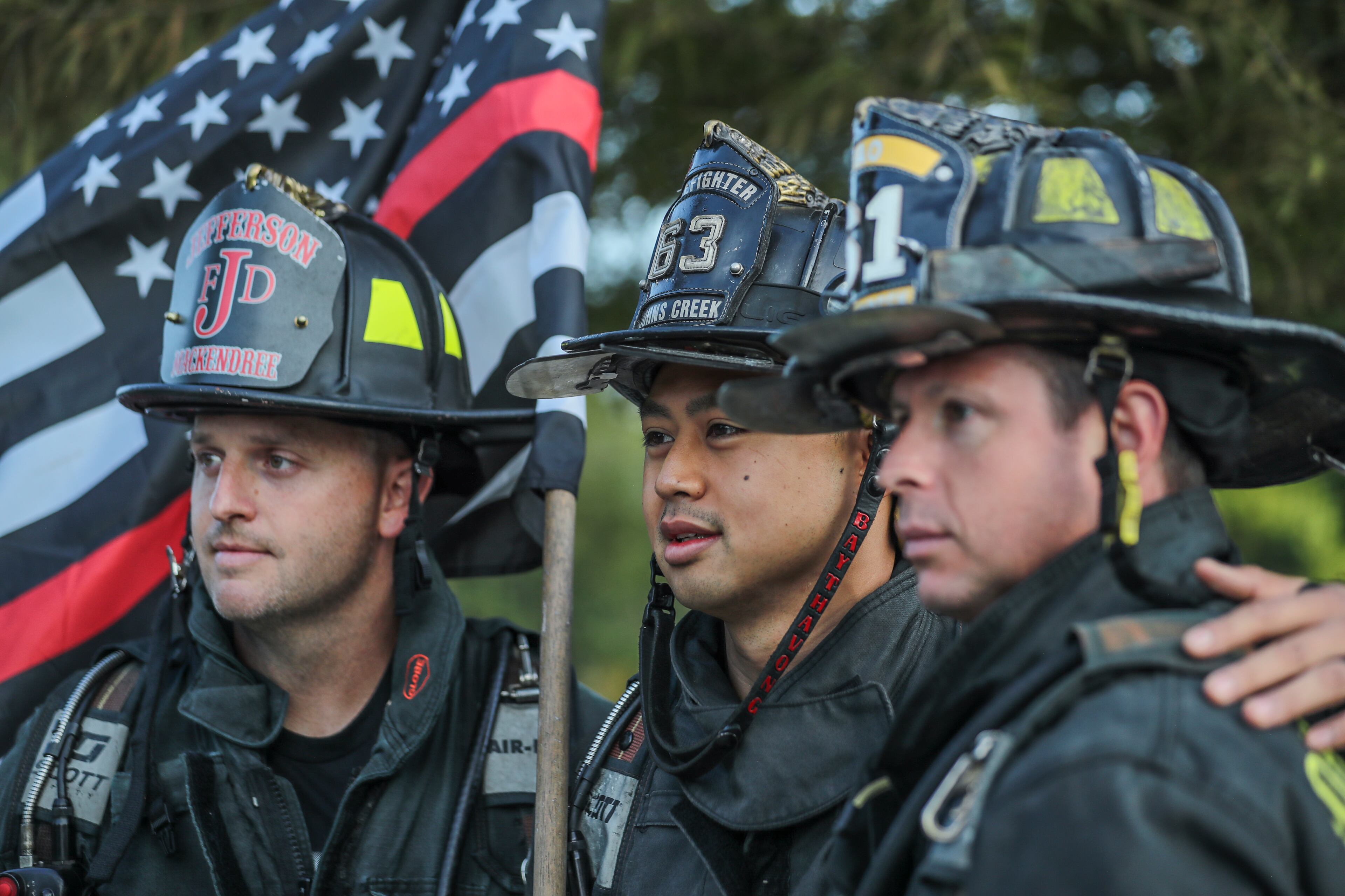 September 11, 2020 Stone Mountain: Johns Creek firefighters (left to right) Michael Mackendree, Kato Baythavong and Kyle Brown prepare to ascend the mountain. Over 100 firefighters from various metro Atlanta Fire departments including: Fayetteville Fire, Fayetteville Police, Fayette County Fire, Henry County Fire, Spalding County Fire, Union City Fire, Morrow Fire, Barrow County Fire, Johns Creek Fire, Gwinnett County Fire and DeKalb County Fire Rescue ascended Stone Mountain on Friday, Sept. 11, 2020 to commemorate the 19th anniversary of the Sept. 11 attacks on the United States. The 6th annual climb was sponsored by the Fayetteville Fire Department who challenged themselves and fellow firefighters to the one-mile climb, equivalent to 160 flights of stairs. Wearing a full complement of firefighting gear, the group tested their endurance in honor of the sacrifices made by 343 firefighters and paramedics who lost their lives on Sept. 11, 2001. Henry County police joined the group. (John Spink / John.Spink@ajc.com)