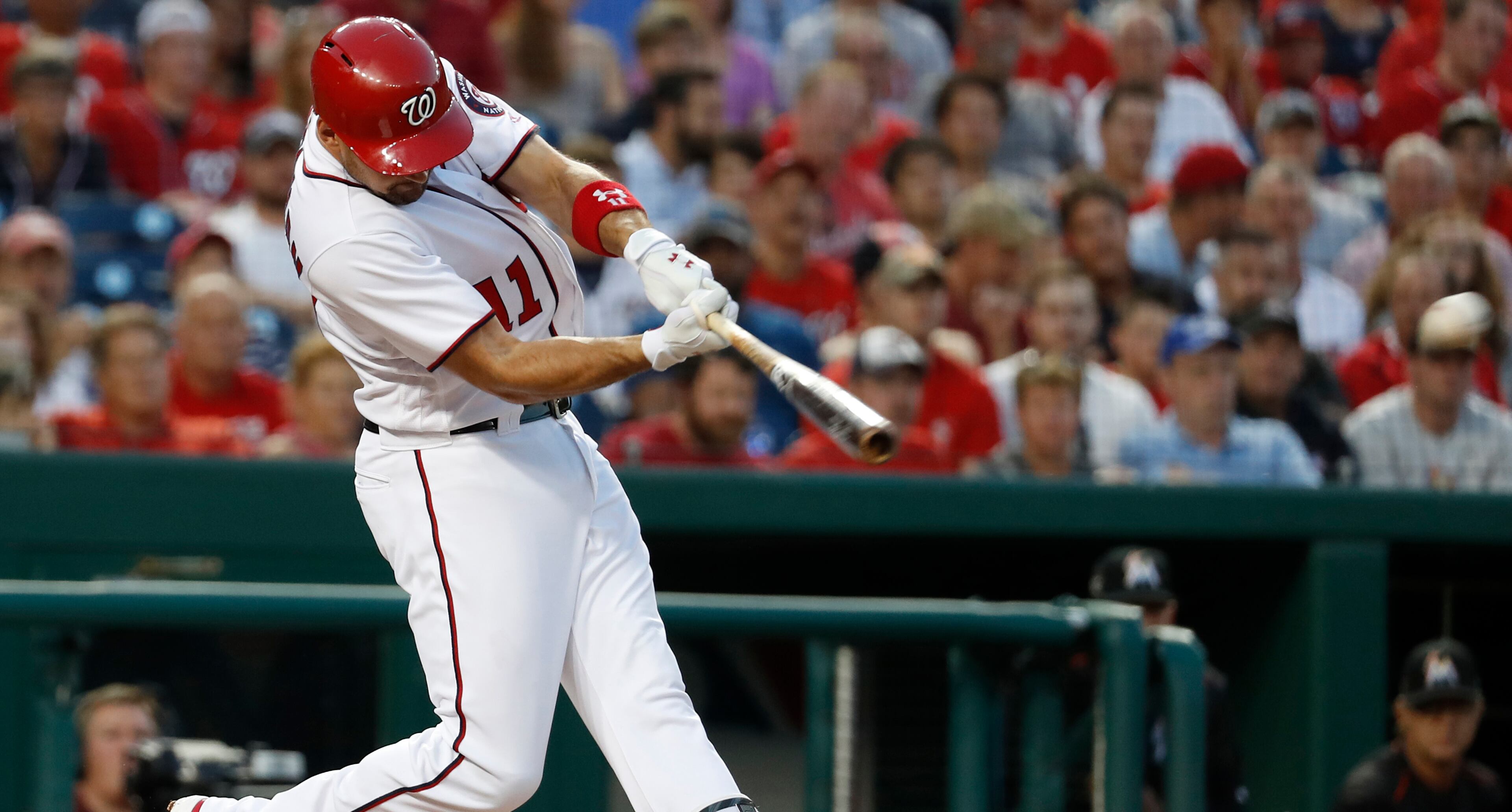 Washington Nationals Ryan Zimmerman (11) hits a double driving in teammate Bryce Harper during the third inning of baseball game against the Miami Marlins, Wednesday, Aug. 9, 2017, in Washington. (AP Photo/Carolyn Kaster)