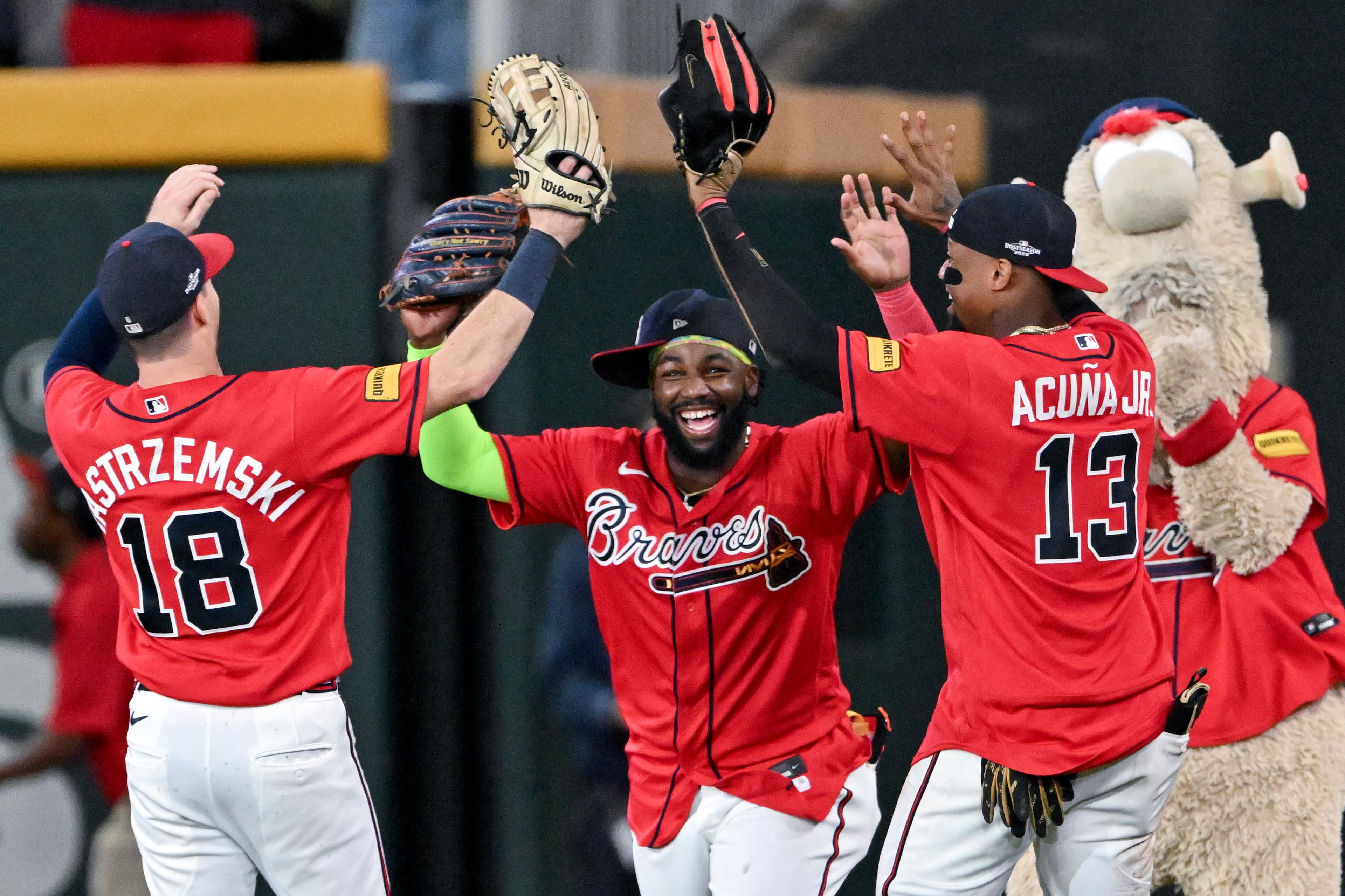 Braves outfielders Mike Yastrzemski (from left), Michael Harris II and Ronald Acuña Jr. celebrate after defeating the Phillies to win their NL Wild Card Series on Thursday, Oct. 1, 2026, in Atlanta. (Hyosub Shin/AJC)