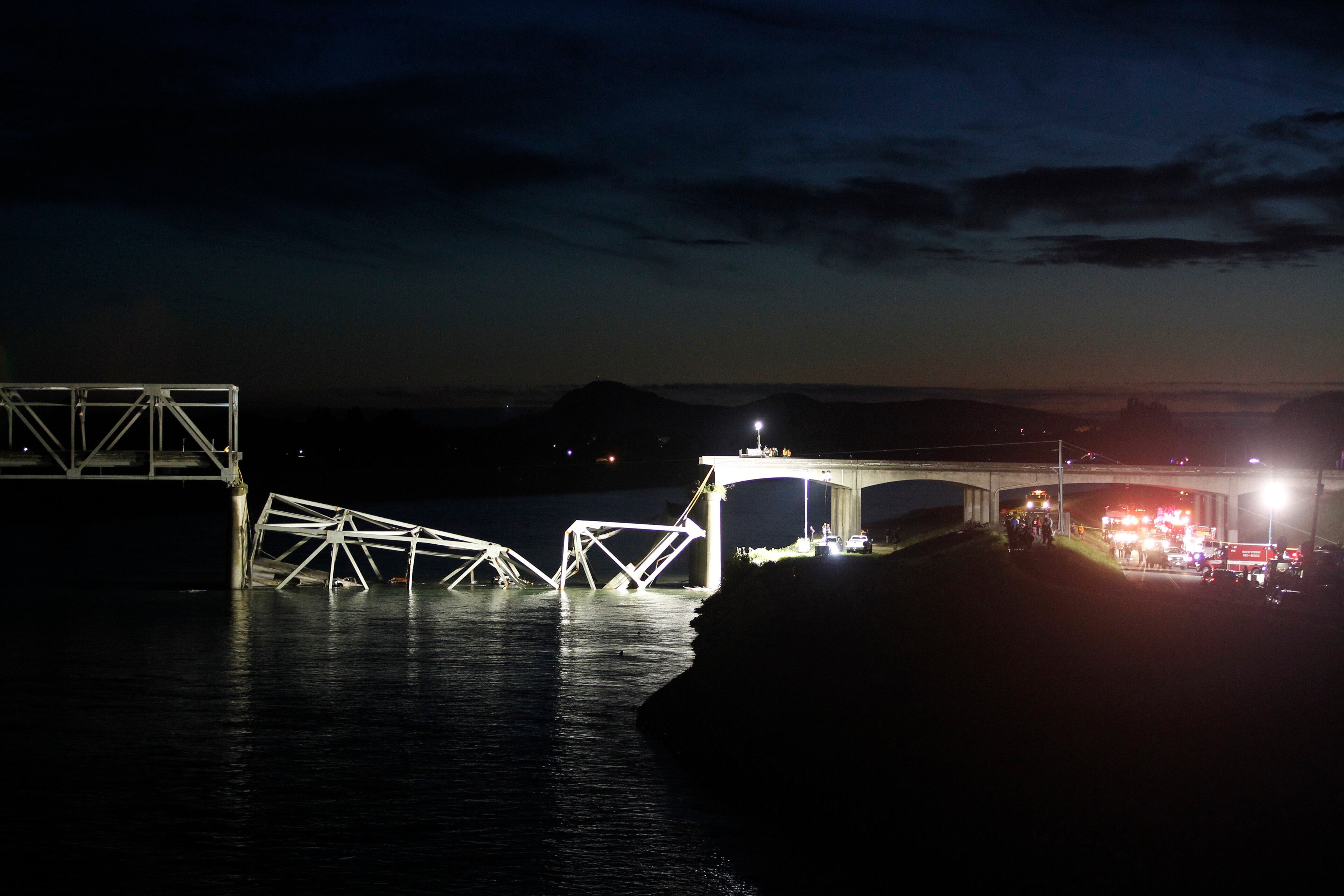 View looking west at a portion of the Interstate-5 bridge submerged after collapsing into the Skagit river dumping vehicles and people into the water in Mount Vernon, Wash., Thursday, May 23, 2013 according to the Washington State Patrol. (AP Photo/Joe Nicholson)