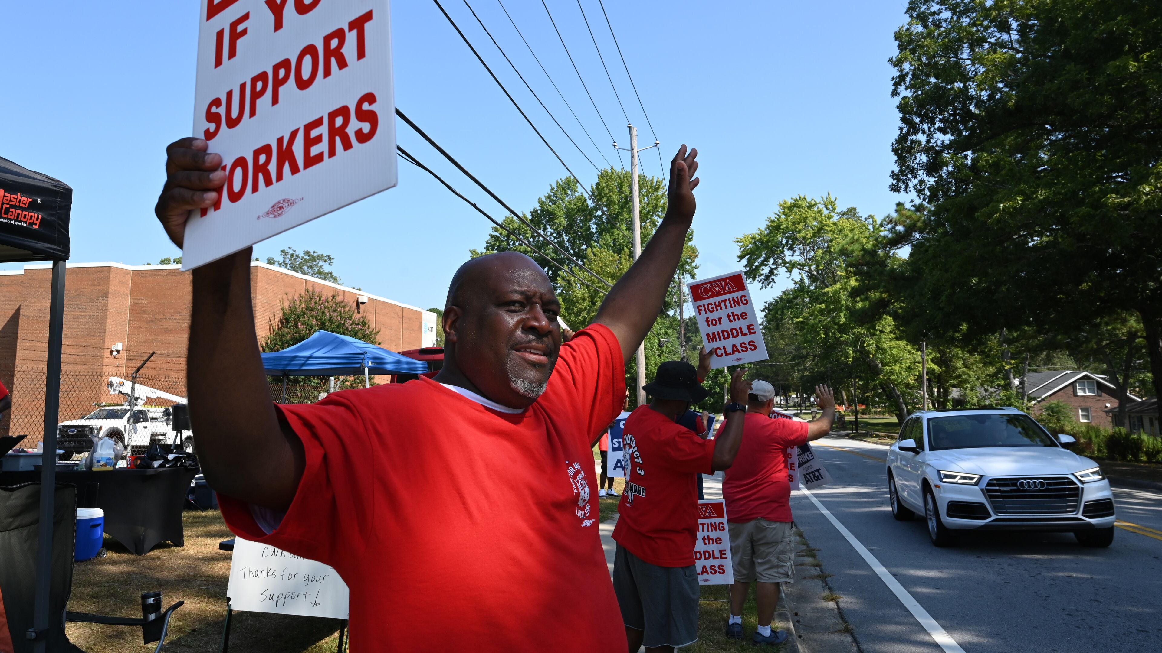 Striking AT&T workers hold signs outside AT&T facility on Brockett Road, Friday, Aug. 30, 2024, in Tucker. Some 17,000 AT&T workers in Atlanta and across the Southeast are on strike, having walked off their jobs on Aug. 16 amid an impasse in contract negotiations. (Hyosub Shin / AJC)
