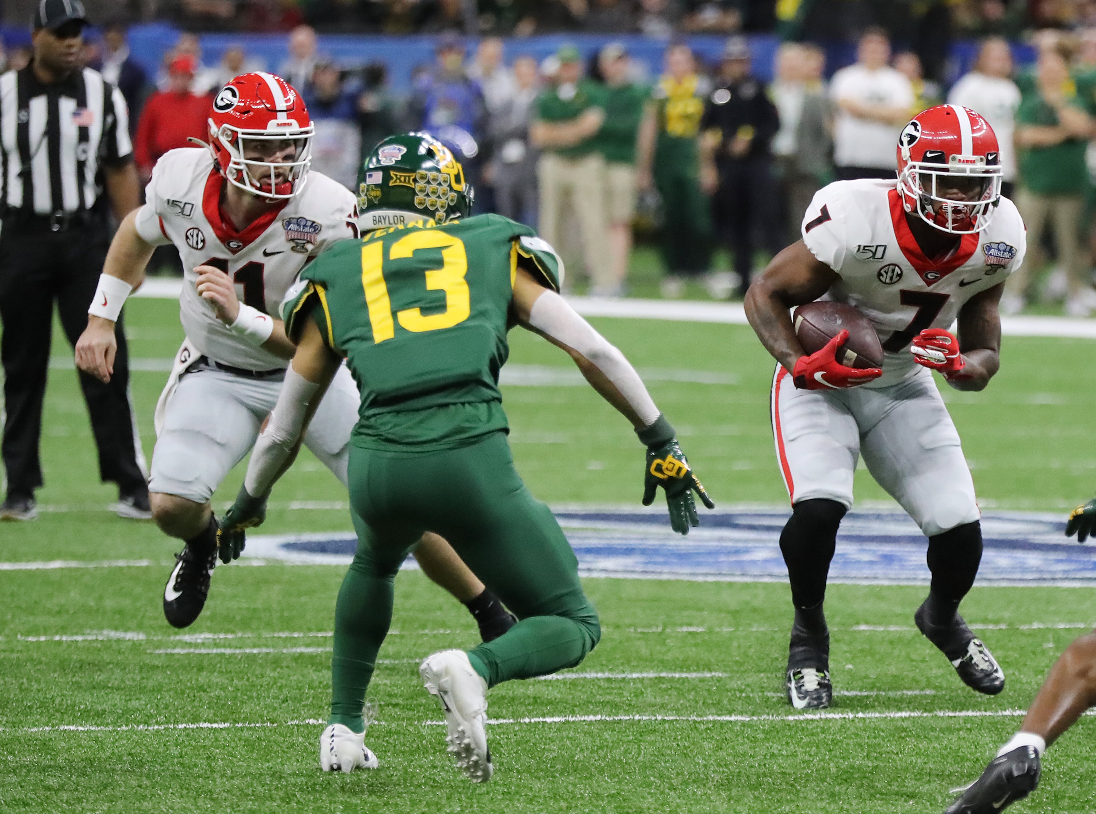 Georgia tailback D'Andre Swift takes the handoff from Jake Fromm during the first quarter against Baylor in the Sugar Bowl NCAA college football game at the Superdome on Wednesday, January 1, 2020, in New Orleans. Curtis Compton ccompton@ajc.com
