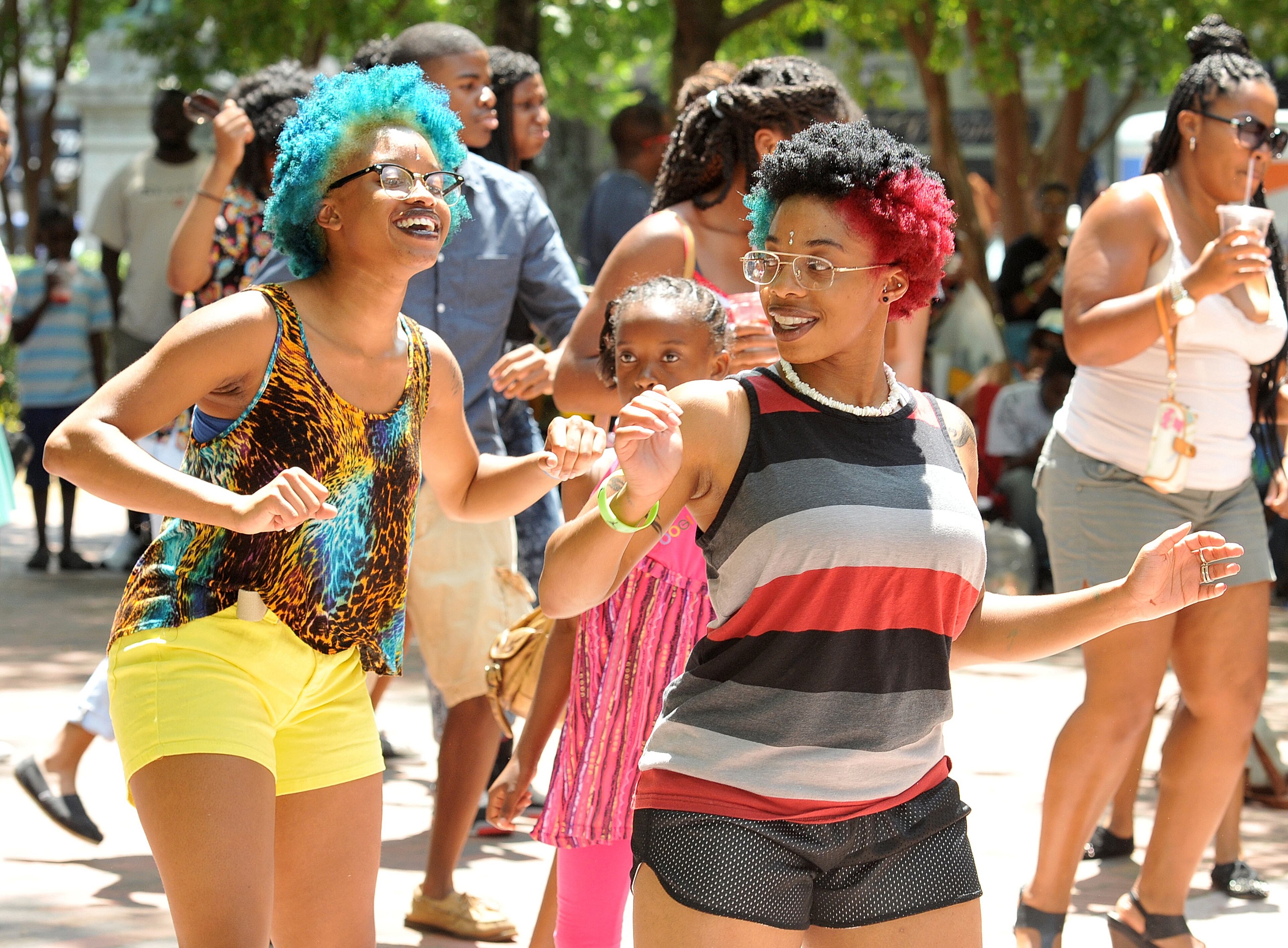 Ka'ia and De'ja (only names given) dance to the beat at the 11th Annual Juneteenth Cultural Festival, hosted by the Cobb County Branch of the NAACP. (PHOTO M. CHRIS HUNT)