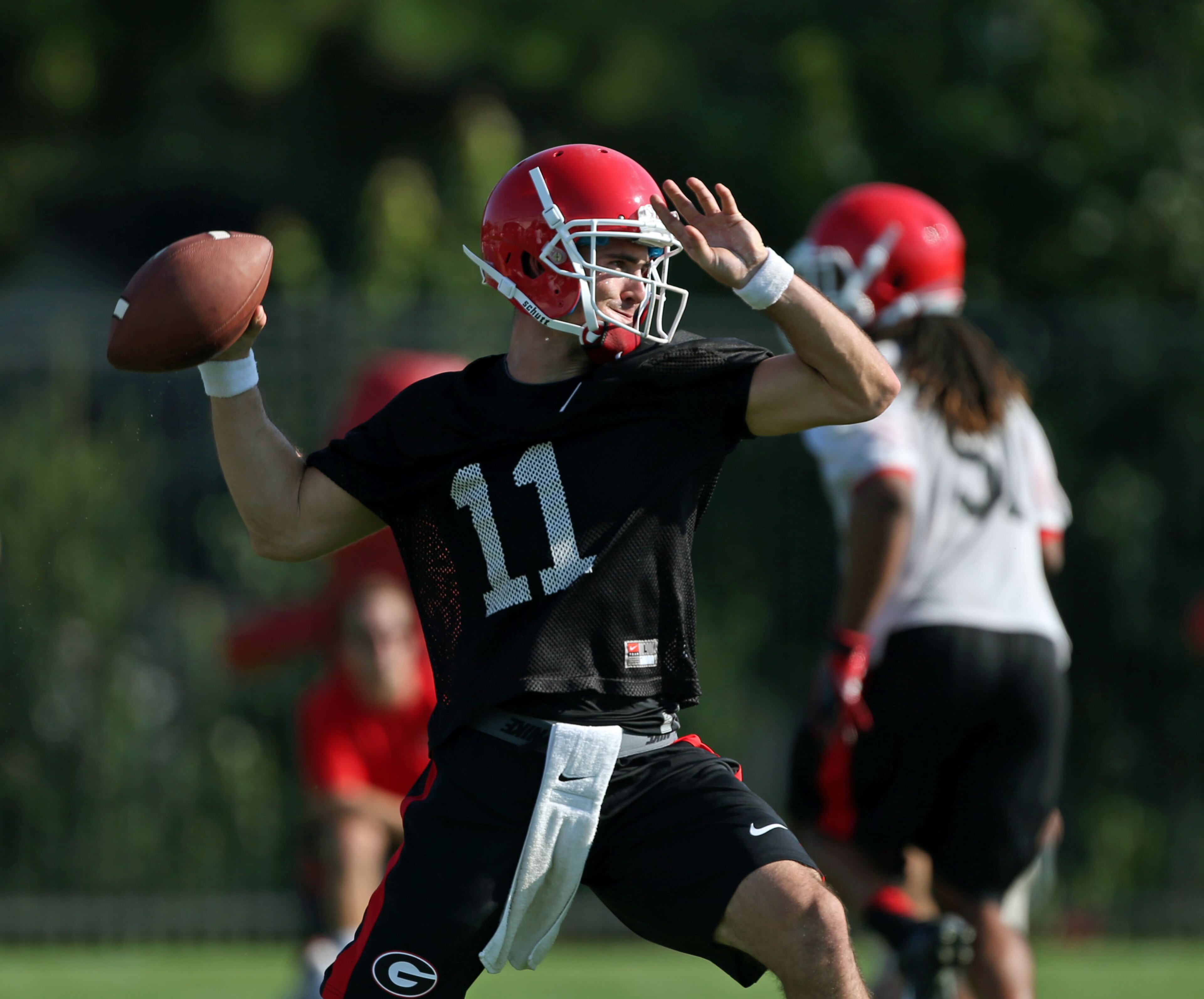 University of Georgia quarterback Aaron Murray (11) attempts a pass during the first day of practice at the University of Georgia Thursday afternoon in Athens, Ga., August 1, 2013. Murray is entering his senior year at Georgia. JASON GETZ / JGETZ@AJC.COM