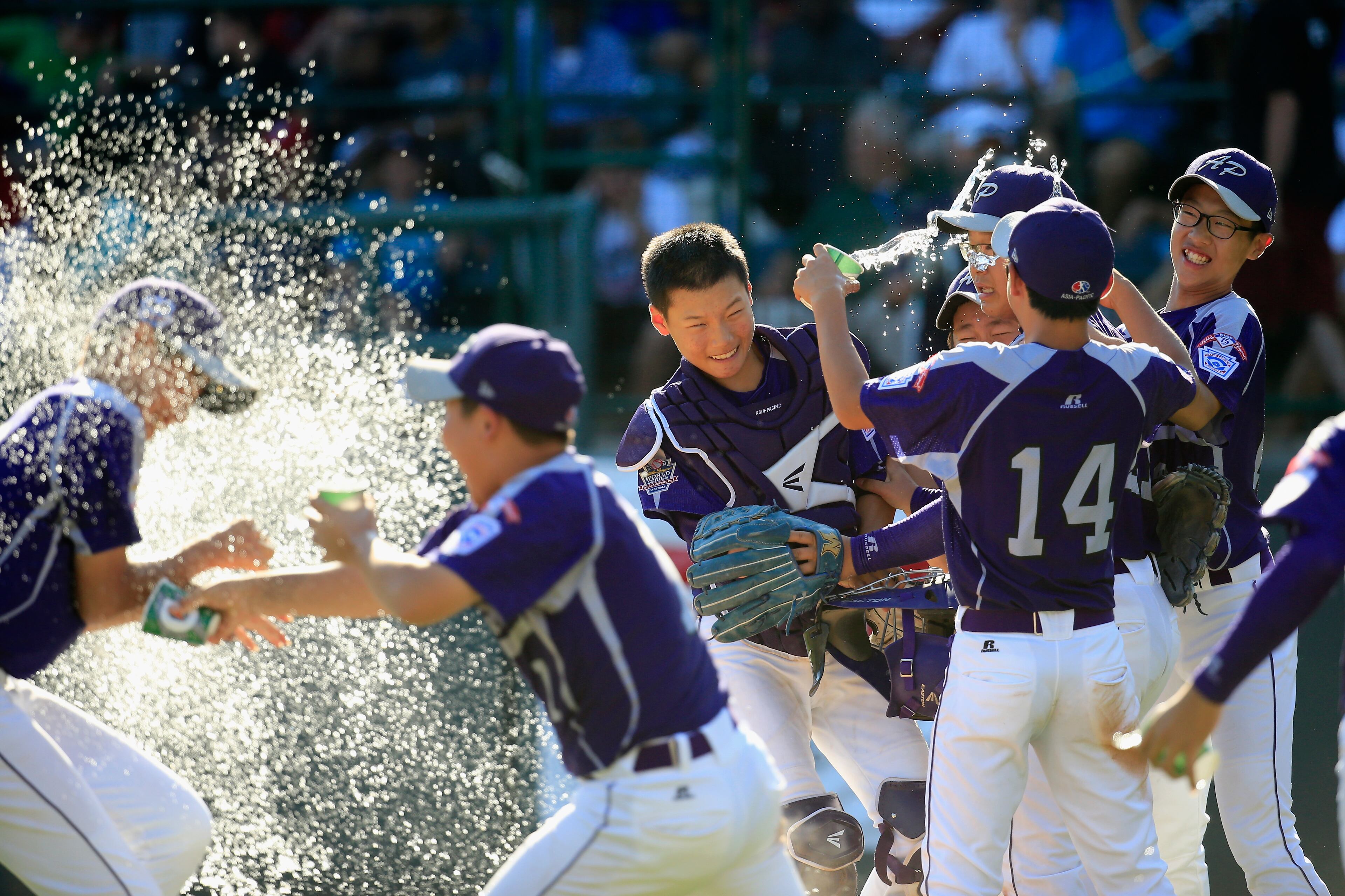 SOUTH WILLIAMSPORT, PA - AUGUST 24: Members of Team Asia-Pacific celebrate following their 8-4 win over the Great Lakes Team from Chicago, Illinois to win the Little League World Series Championship game at Lamade Stadium on August 24, 2014 in South Williamsport, Pennsylvania. (Photo by Rob Carr/Getty Images)