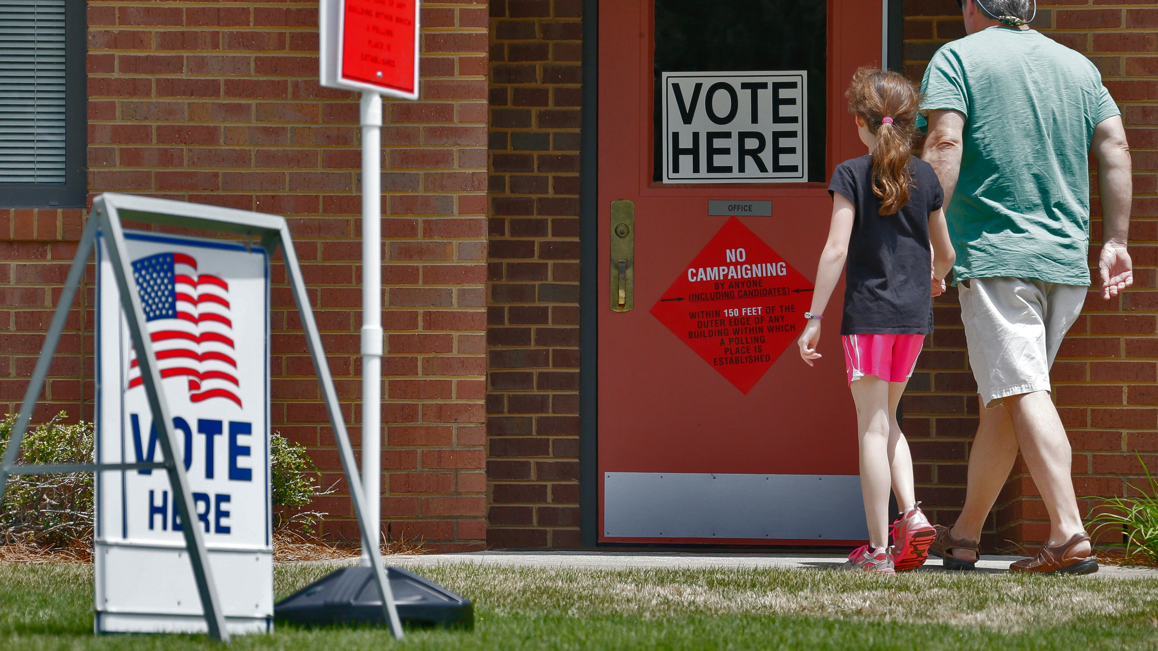 A steady flow of voters entered the polling place at Beautiful Savior Lutheran Church on Shallowford Rd. in Marietta. BOB ANDRES / BANDRES@AJC.COM