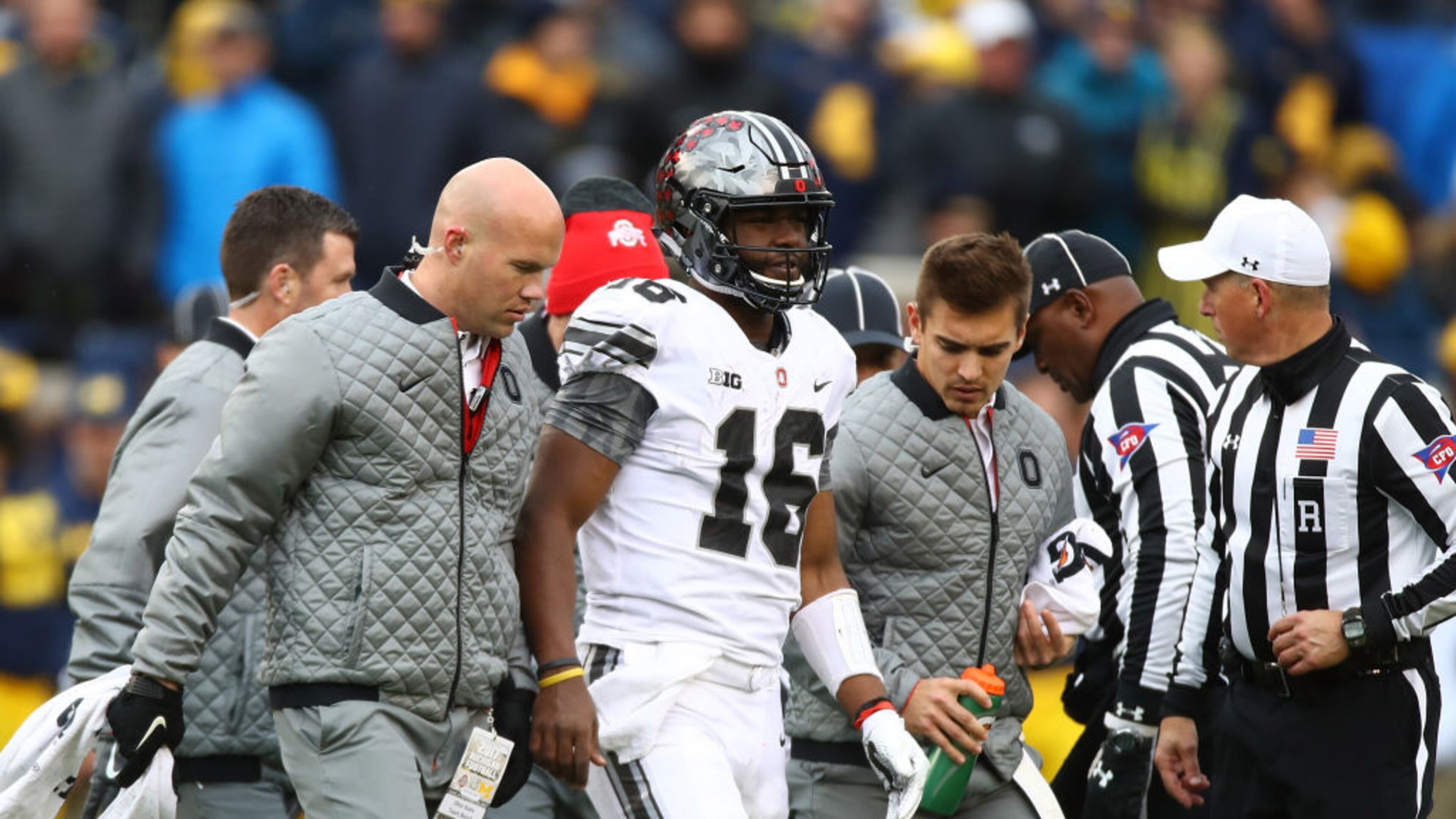 Ohio State quarterback J.T. Barrett injured his knee and left the game during the third quarter of Saturday's victory against Michigan. Barrett also hurt his knee before the game when he was bumped by a photographer on the sideline.