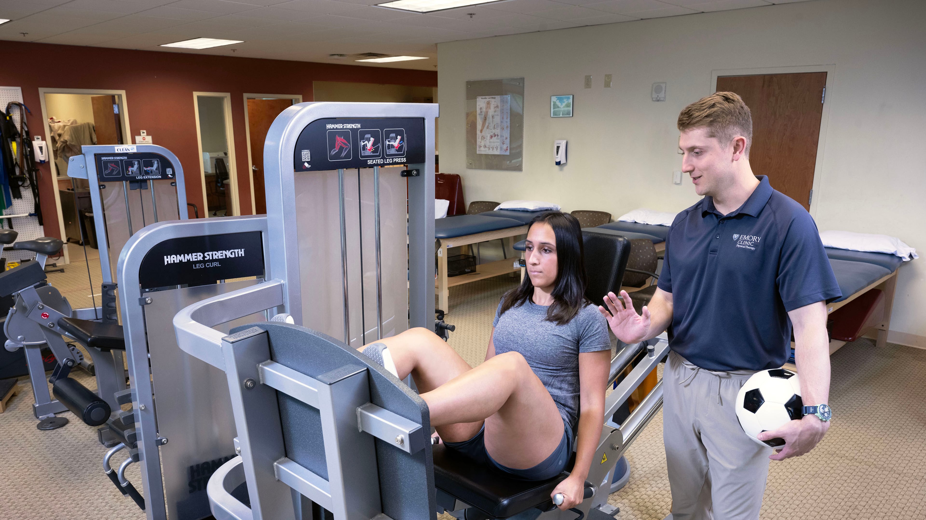 Sports medicine physical therapist Carl Guidry (right) trains Katherine Kutscera at Emory Johns Creek Hospital. (Jack Kearse/Courtesy of Emory University)