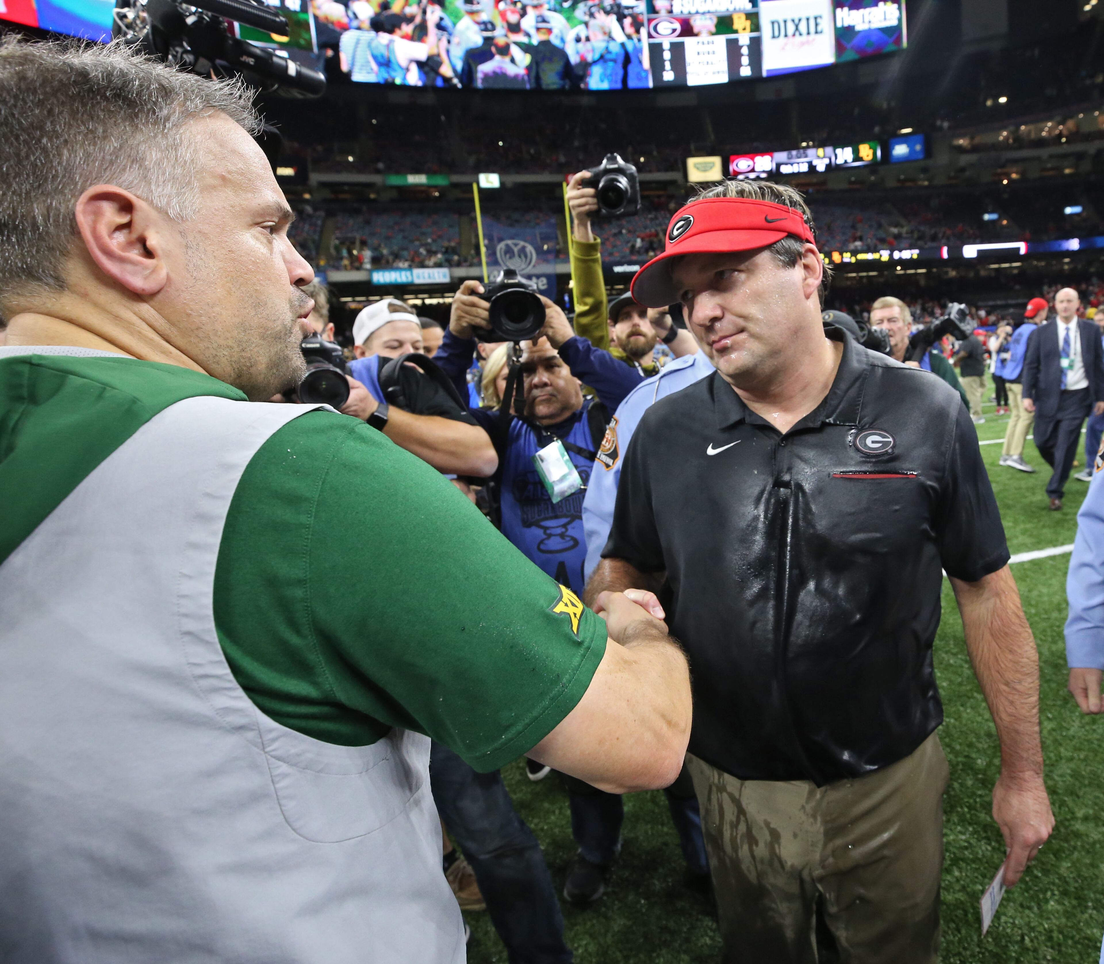 Baylor Bears head coach Matt Rhule (left) congratulates a wet Georgia Bulldogs head coach Kirby Smart after the Sugar Bowl. Bob Andres bandres@ajc.com