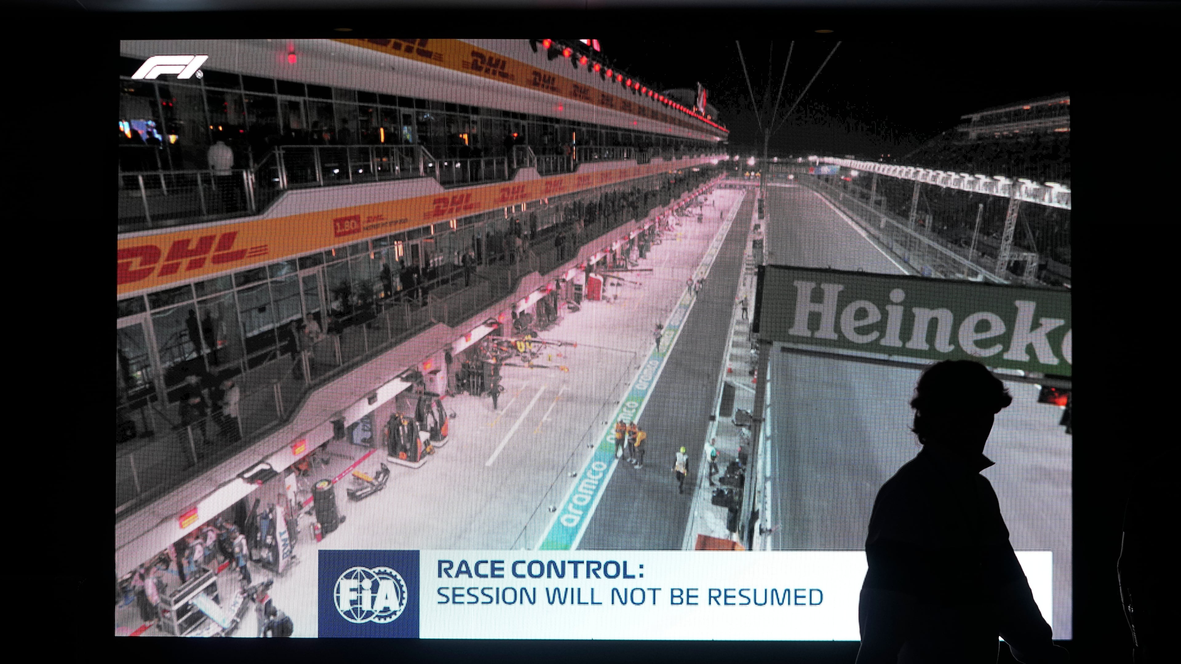 FILE - A fan walks pass a video board after the first practice session for the Formula One Las Vegas Grand Prix auto race was stopped, Thursday, Nov. 16, 2023, in Las Vegas. (AP Photo/Darron Cummings, File)