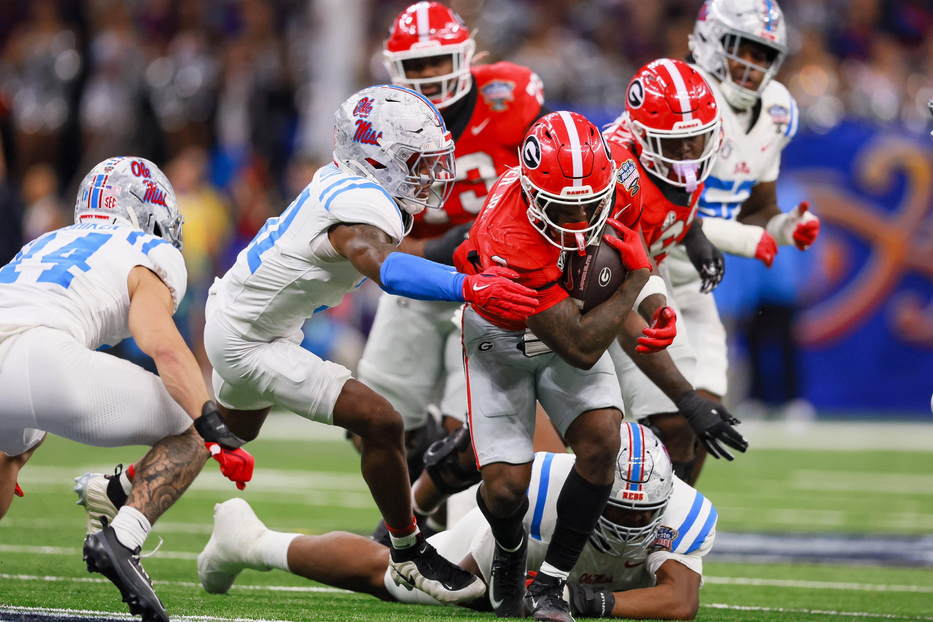 Georgia Bulldogs running back Nate Frazier (3) drives for extra yardage and a first down against the Ole Miss Rebels during the first half of the Georgia vs. Ole Miss NCAA College Football Playoff quarterfinal game at the Sugar Bowl in the Caesars Superdome, Thursday, Jan. 1, 2026, in New Orleans. (Jason Getz/AJC)