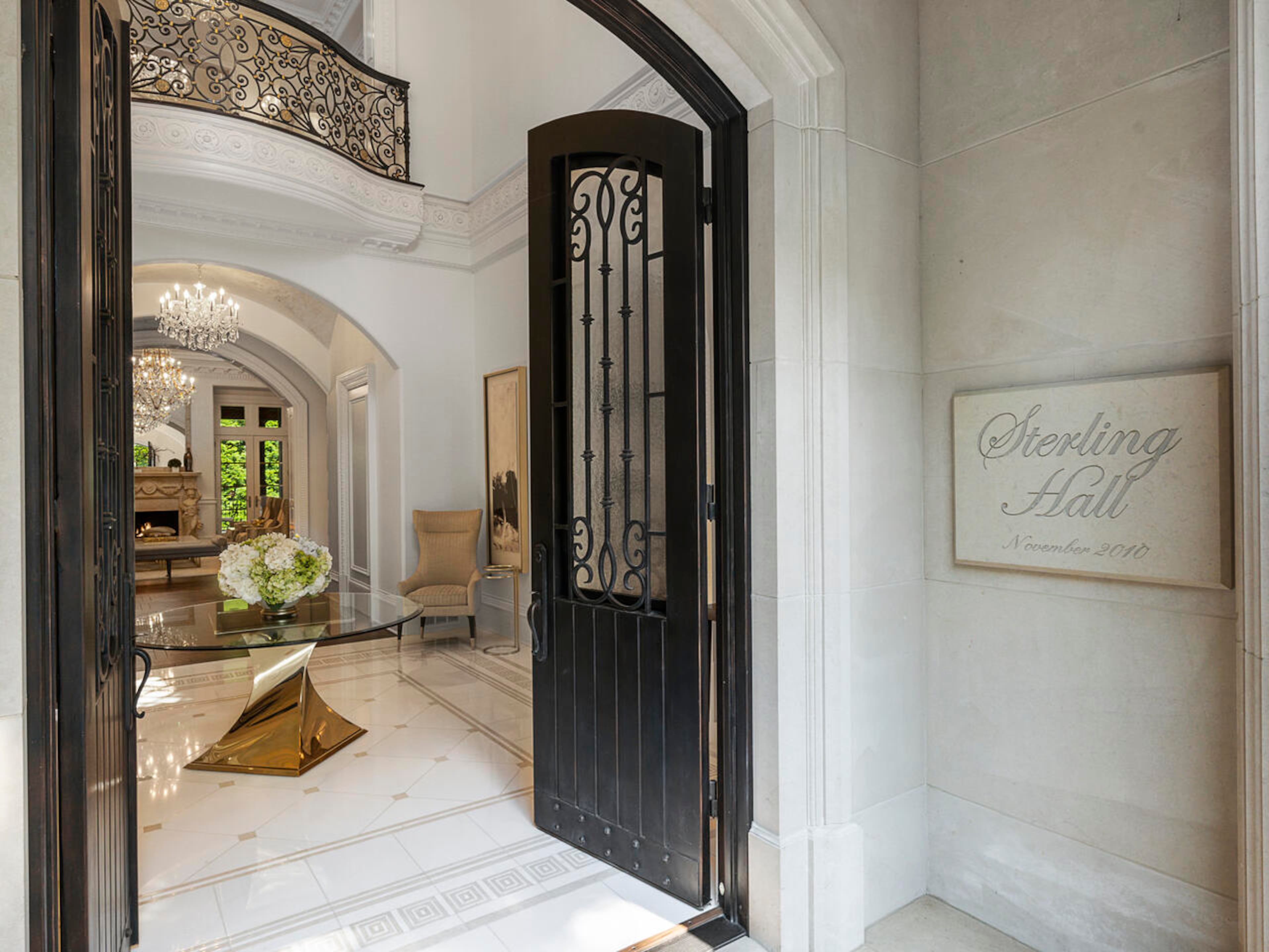 Upon entry to the home, a two-story, 24-foot ceiling foyer with a gold leaf dome, crystal chandelier, and Juliet balcony greets guests. Arched entryways lead from the foyer to the study, living room, and dining room. Text by Elizabeth Manderson and Julie Pedersen/Photo by Ilya Zobanov, Gold Lens Media.