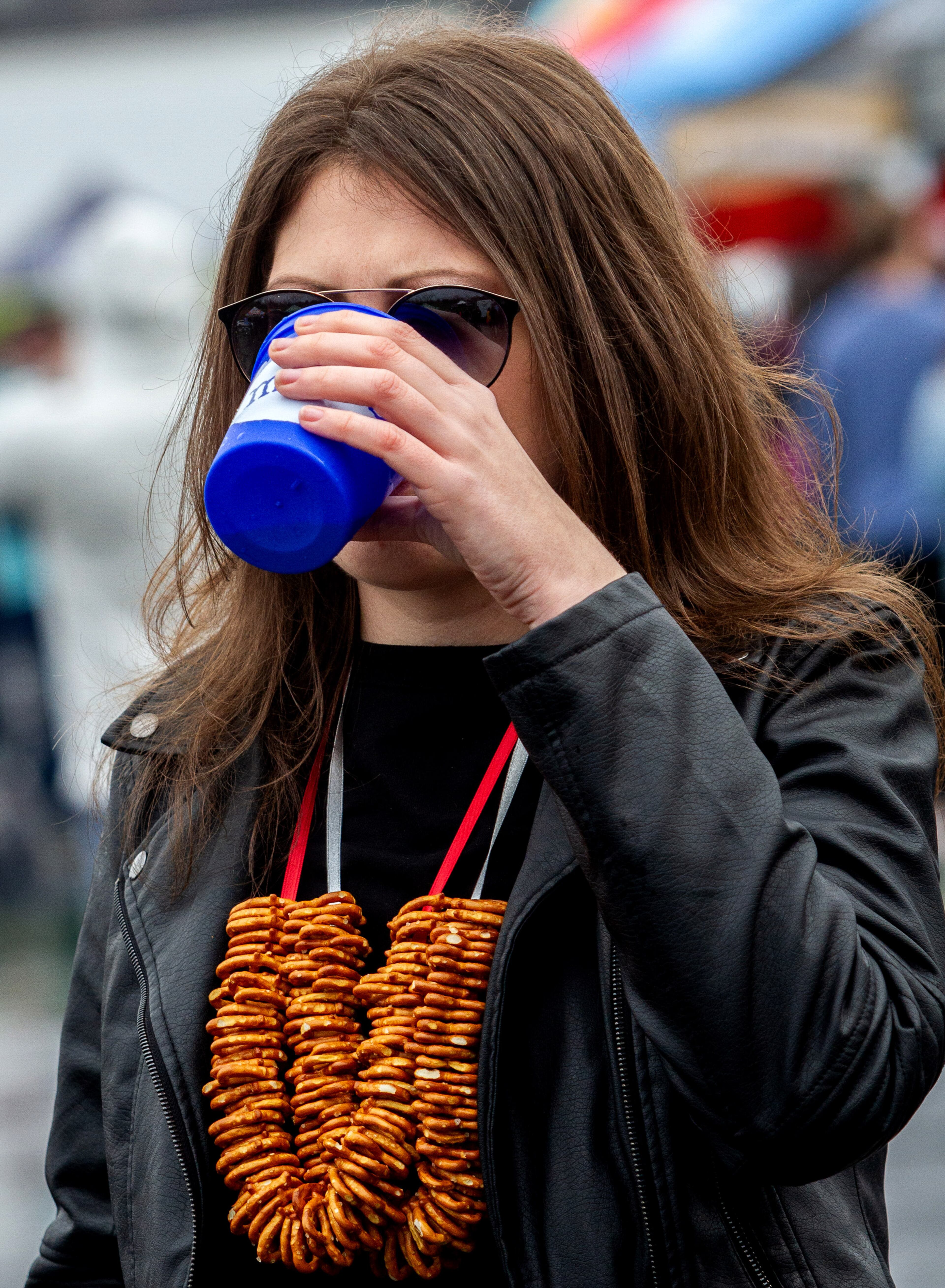 Alina Churilova takes a drink of beer while wearing her pretzel neckless during the Atlanta Winter Beer Festival at Atlantic Station on Saturday, February 1, 2020. STEVE SCHAEFER / SPECIAL TO THE AJC
