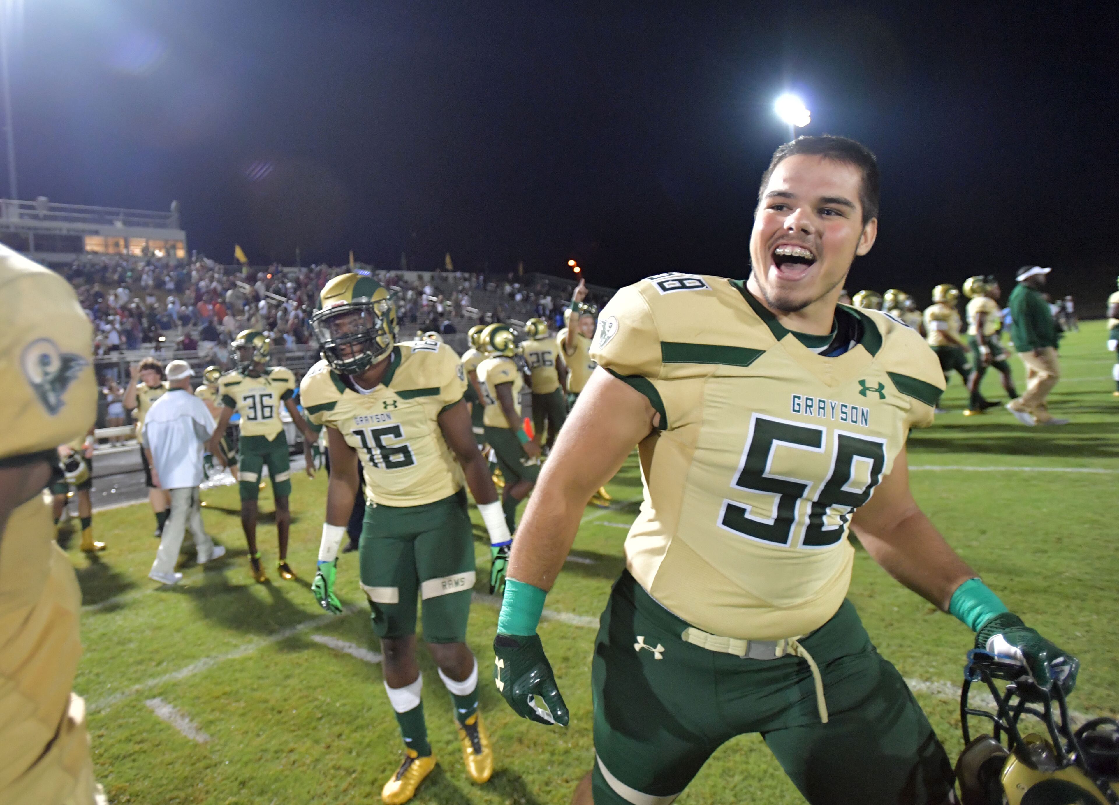 Rijad Huskovic (58) and other Grayson players celebrate their win over the McEachern at Grayson High School in Loganville on Friday, September 1, 2017. Grayson won 12-7 over the McEachern. HYOSUB SHIN / HSHIN@AJC.COM