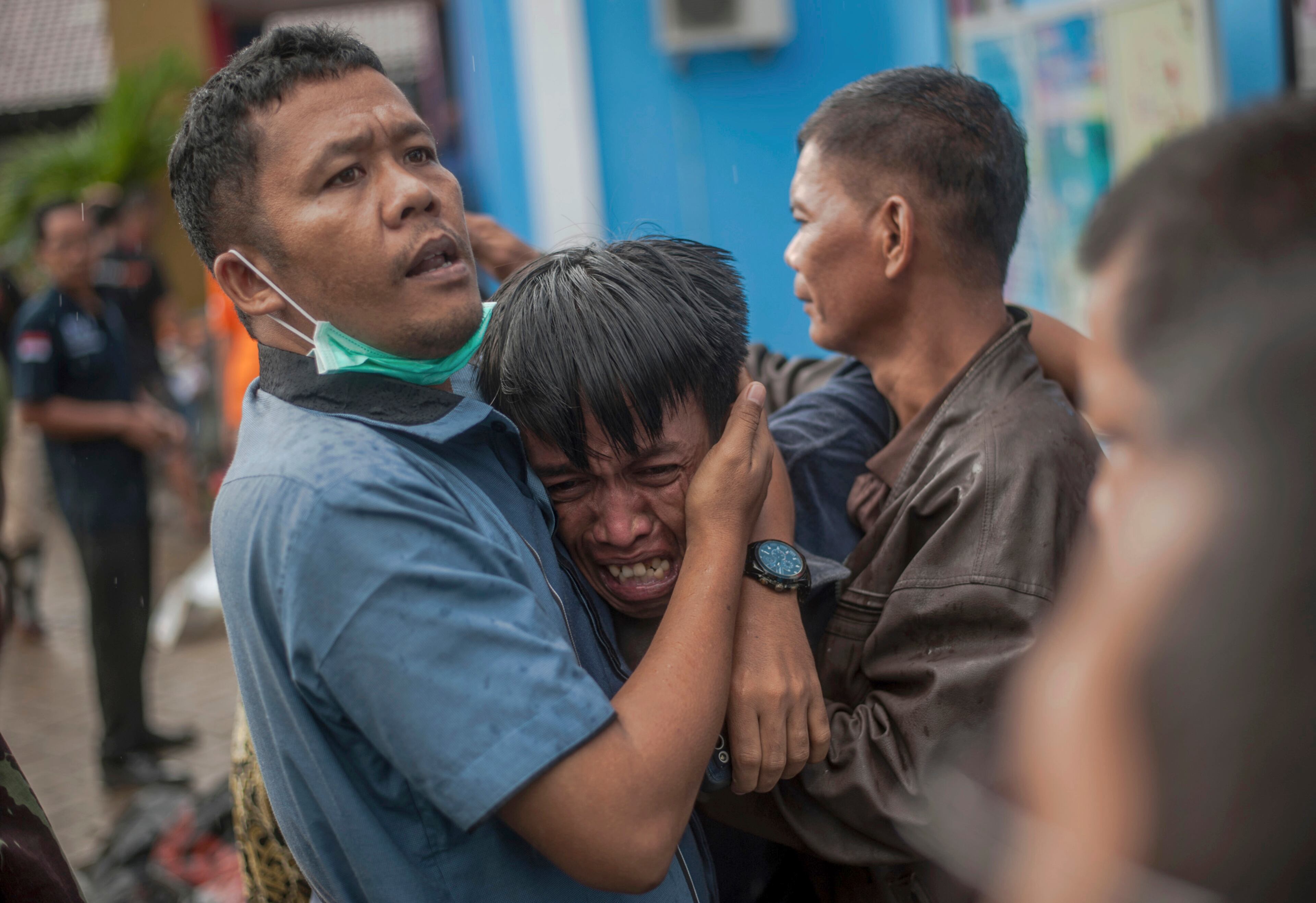 A man reacts after identifying his relative among the bodies of tsunami victims.