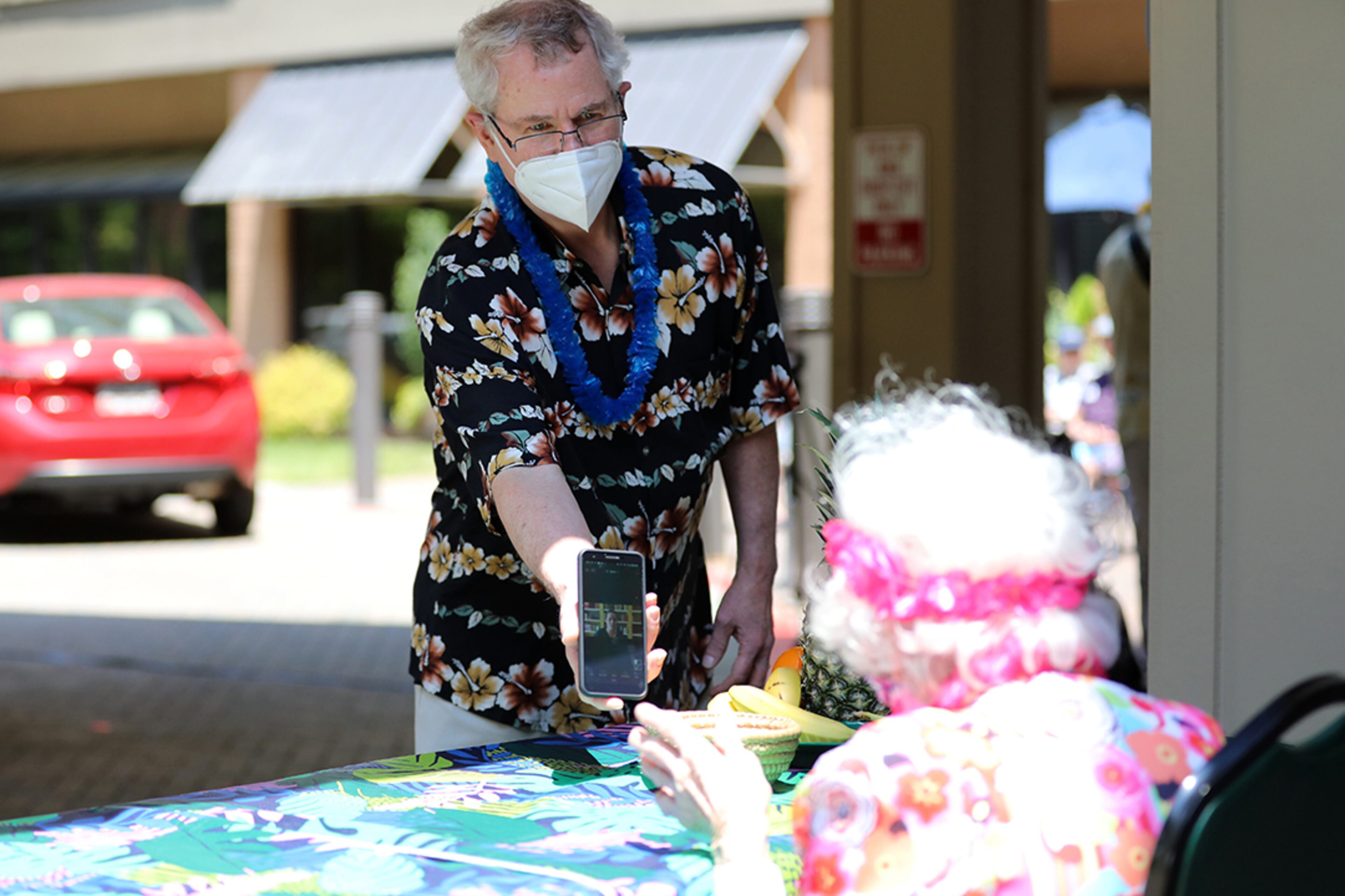 Peggy Cobb's son Bill Cobb, 72, of Decatur, holds his cellphone while his daughter in California sings "Happy Birthday" to her grandmother on Friday, May 22, 2020. (Photo: Miguel Martinez for The Atlanta Journal-Constitution)