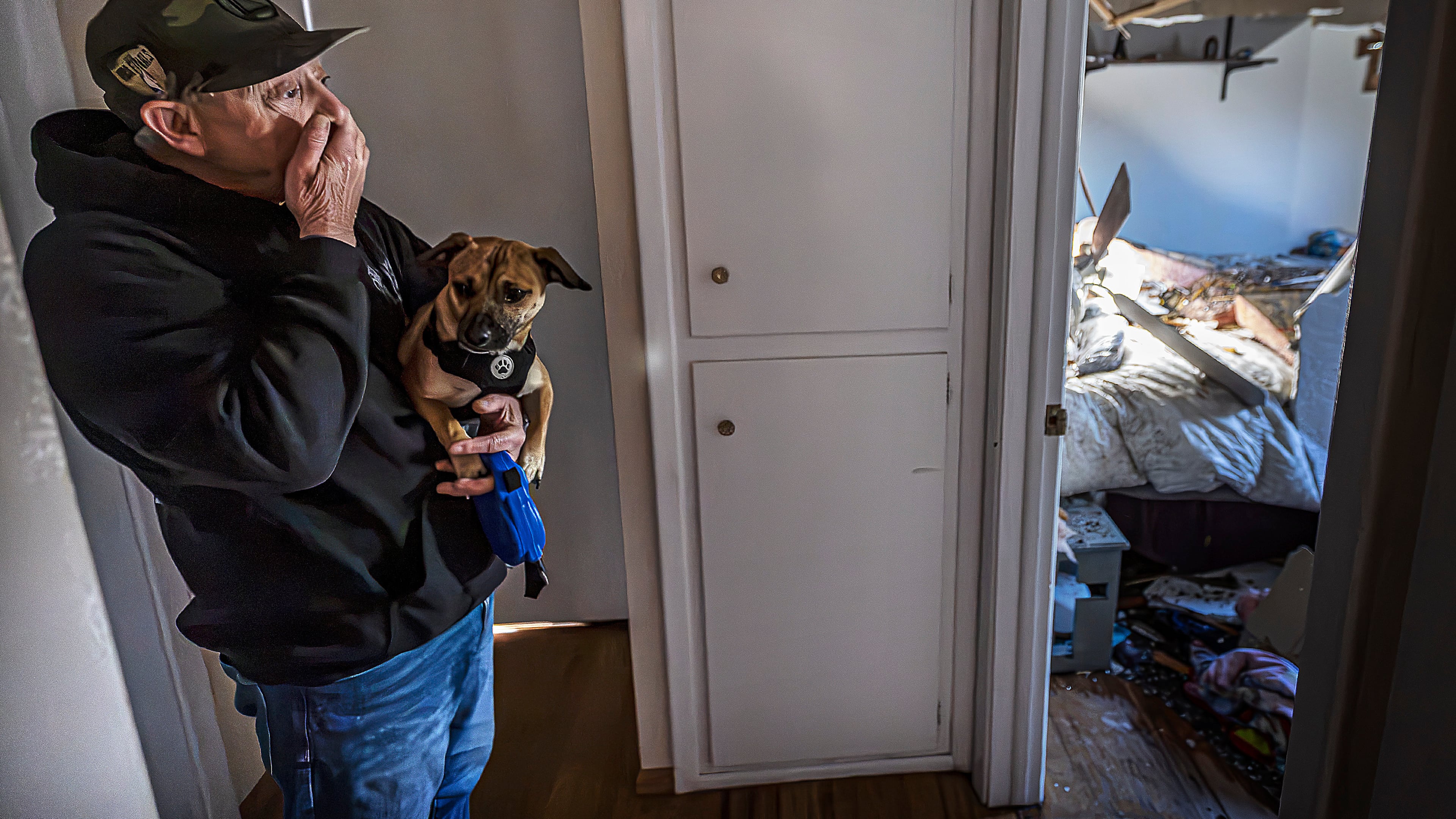 Gary Delgado looks at damage of his home including the partially collapsed roof in Santa Fe, N.M., Sunday, Oct. 25, 2026, following a tornado that touched down in central Santa Fe on Saturday night. (Jim Weber/Santa Fe New Mexican via AP)