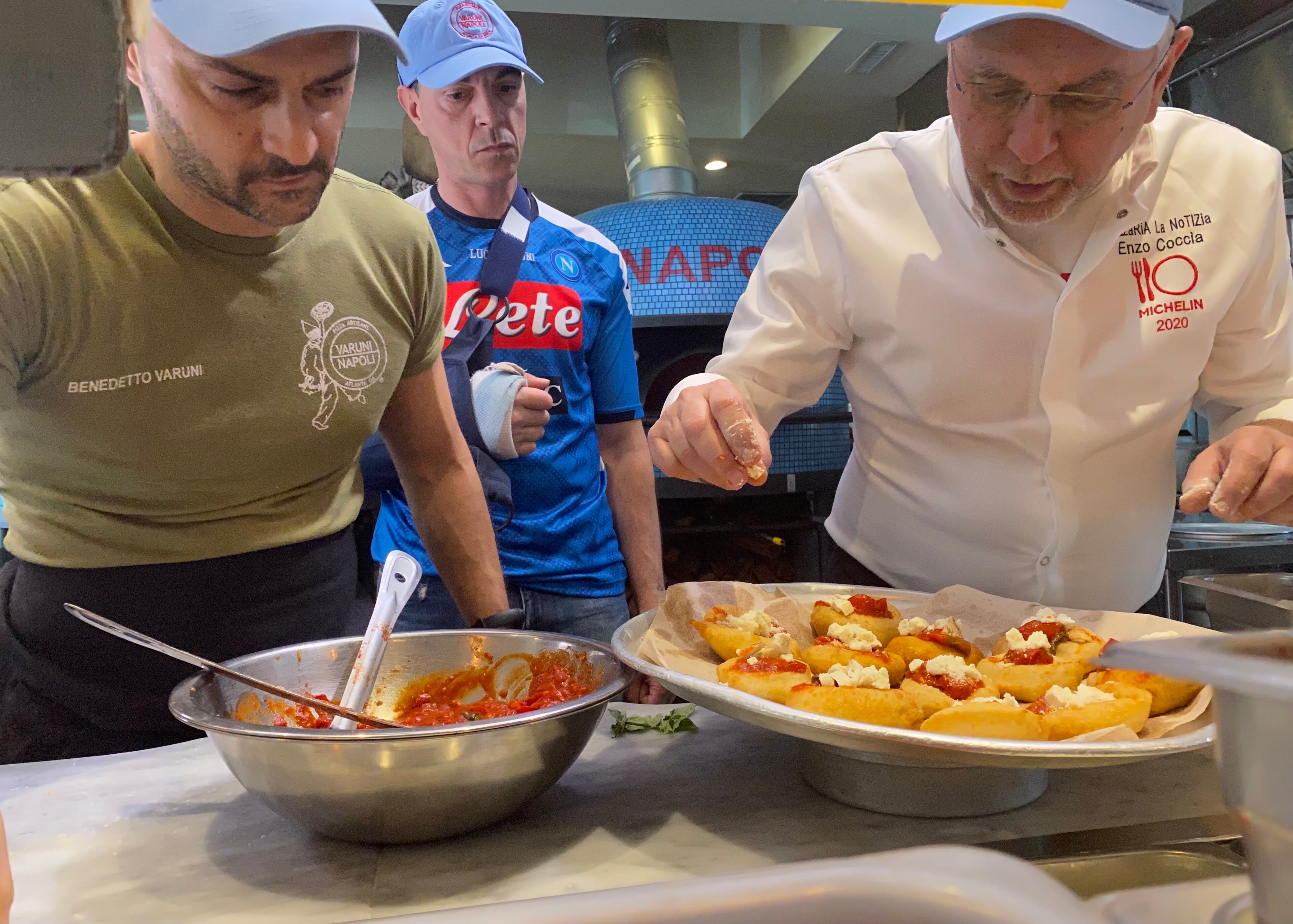 Varuni Napoli owner Luca Varuni (center) and his brother Benedetto (left), work with Enzo Coccia on fried calzones for a multi-course pizza tasting in April. Ligaya Figueras/ligaya.figueras@ajc.com
