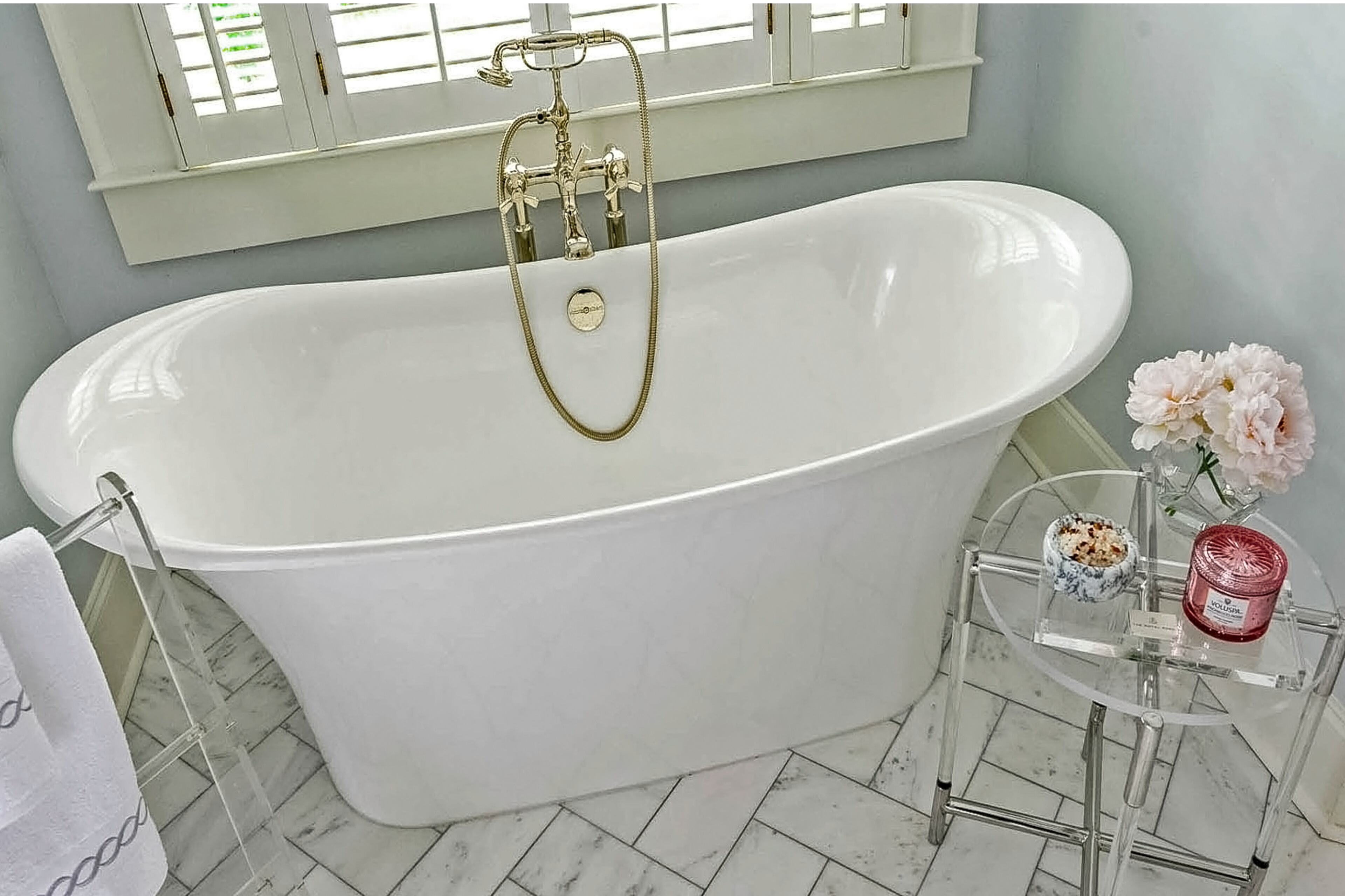 A freestanding tub and Carrara marble floors in a herringbone pattern were added in the renovations.