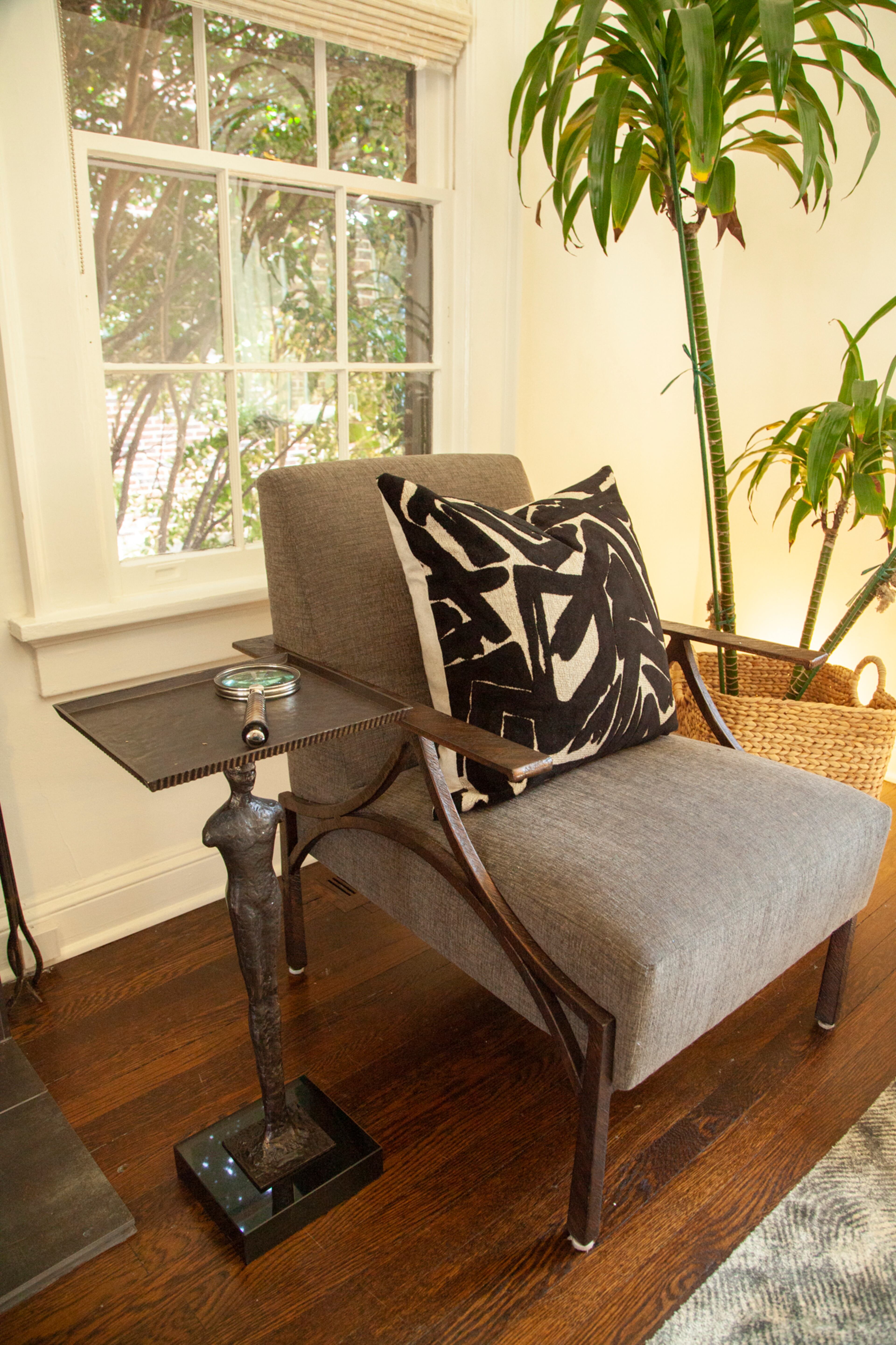 The use of various metal pieces, including the upholstered chairs by Bernhardt Furniture Company and the side table by Global Views, add interest.