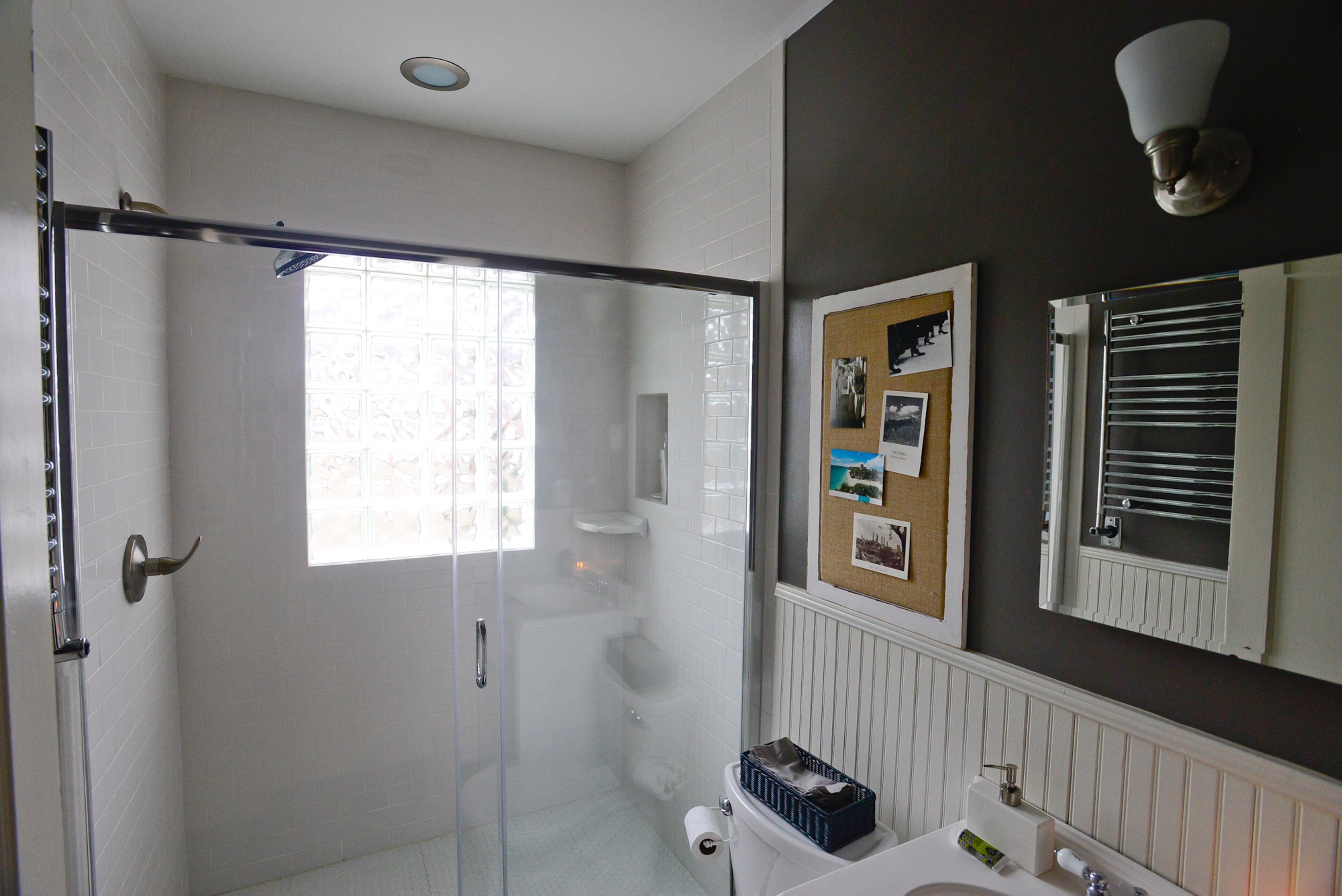Subway tile and beadboard in one of the bathrooms fit with the home's cottage vibe.