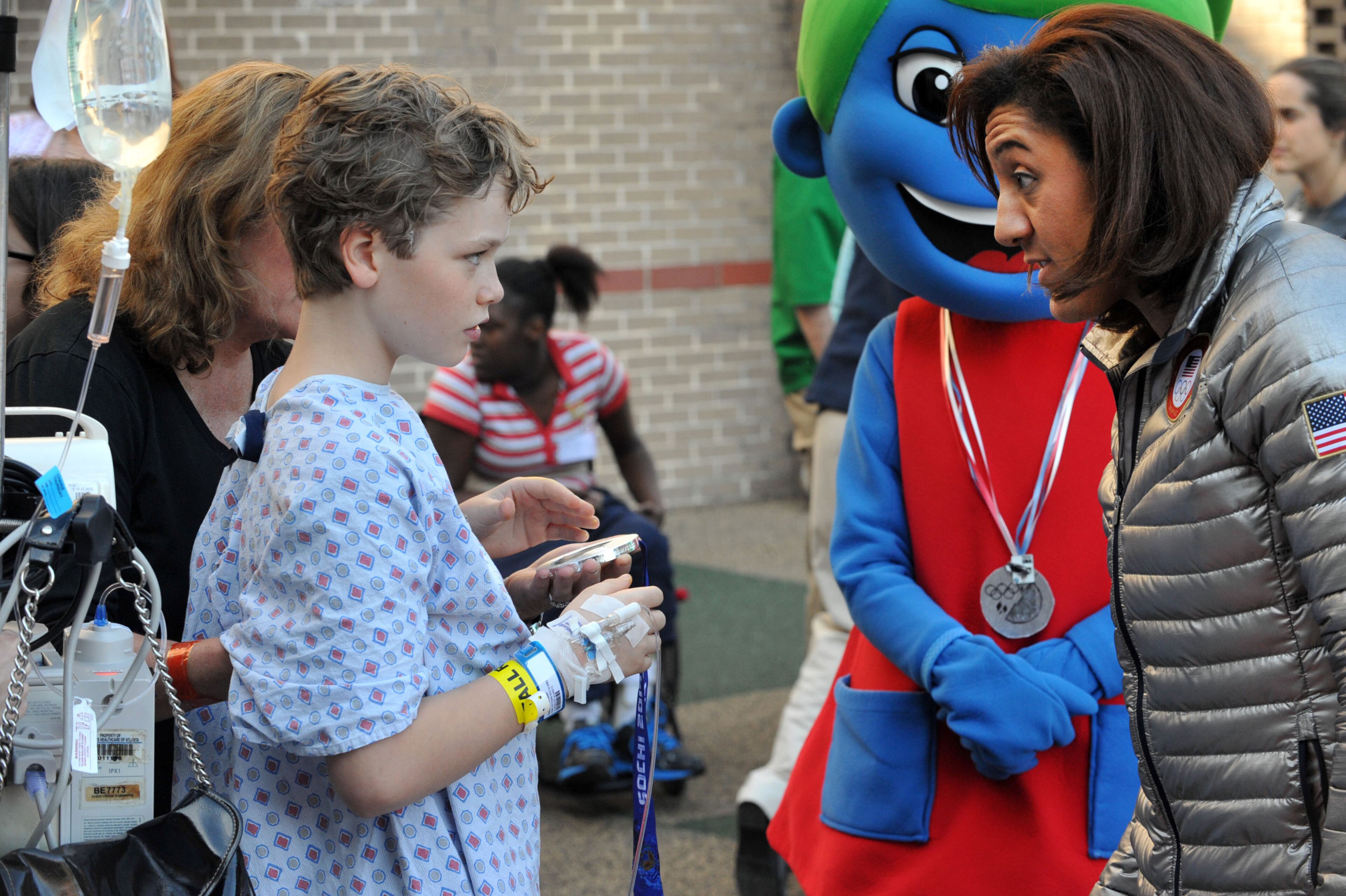 Douglasville-native Elana Meyers talks with Matthew Edson, 13, of Atlanta, as she shares her silver medal from the Winter Olympic Games with patients during a visit to The Zone at Children's Healthcare of Atlanta at Scottish Rite Monday, Feb. 24, 2014. KENT D. JOHNSON / KDJOHNSON@AJC.COM