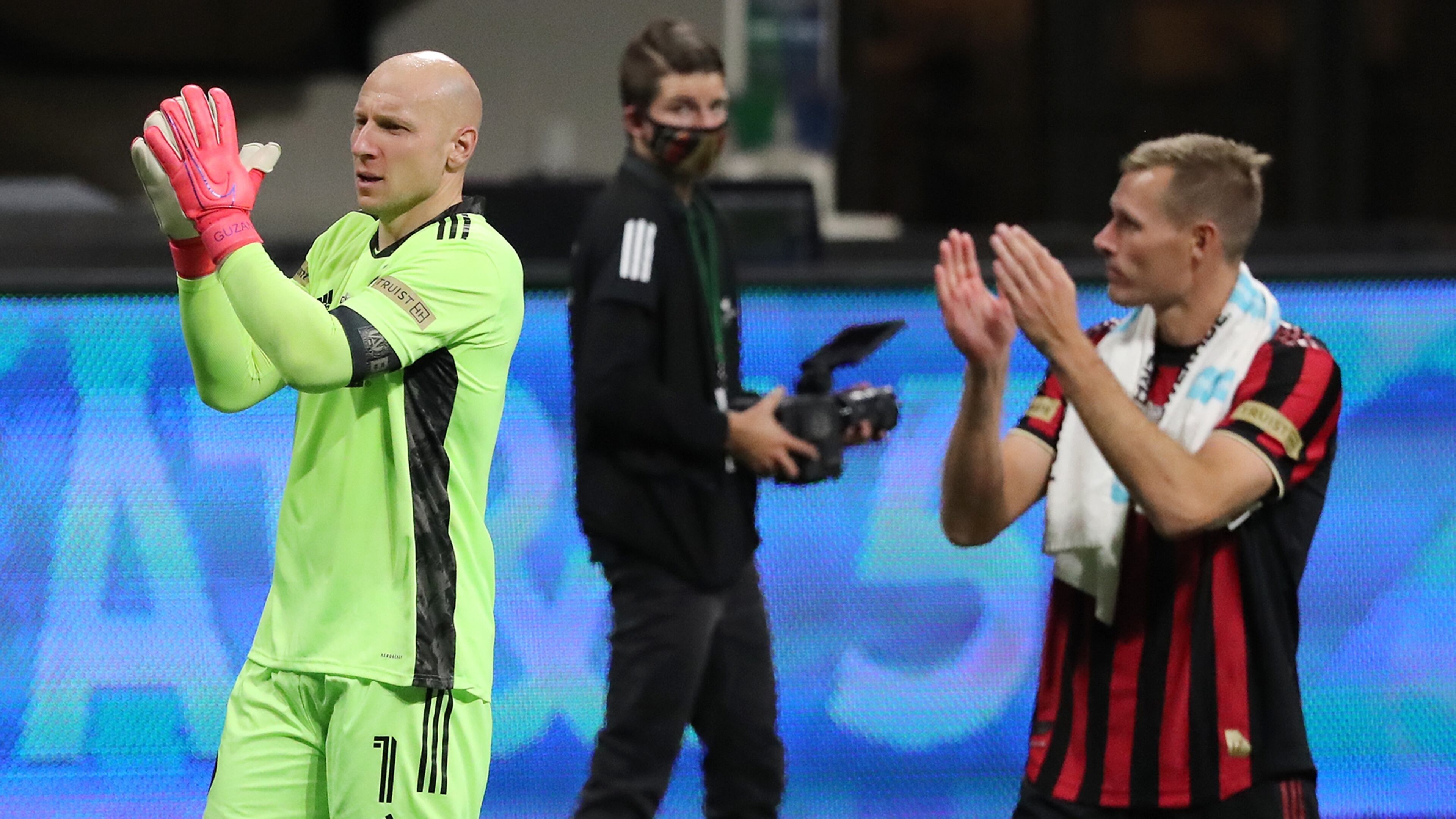 Atlanta United goalkeeper Brad Guzan (left) and forward Adam Jahn celebrate a 2-0 victory over Cincinnati Sunday, Nov. 1, 2020, at Mercedes-Benz Stadium in Atlanta. (Curtis Compton / Curtis.Compton@ajc.com)