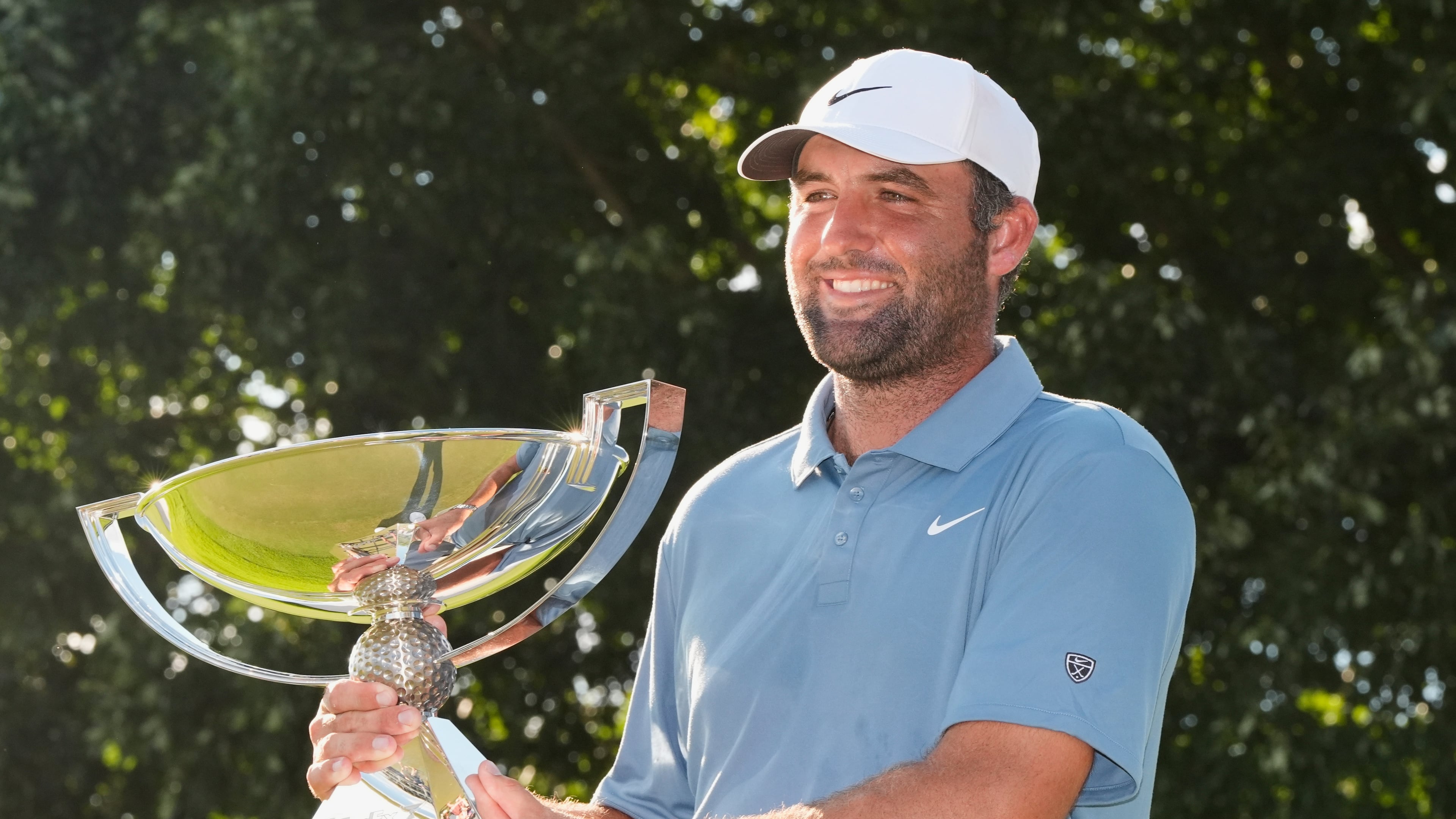 Scottie Scheffler holds the trophy after winning the PGA Tour Championship golf tournament Sunday, Aug. 30, 2026, in Atlanta. (AP Photo/Mike Stewart)