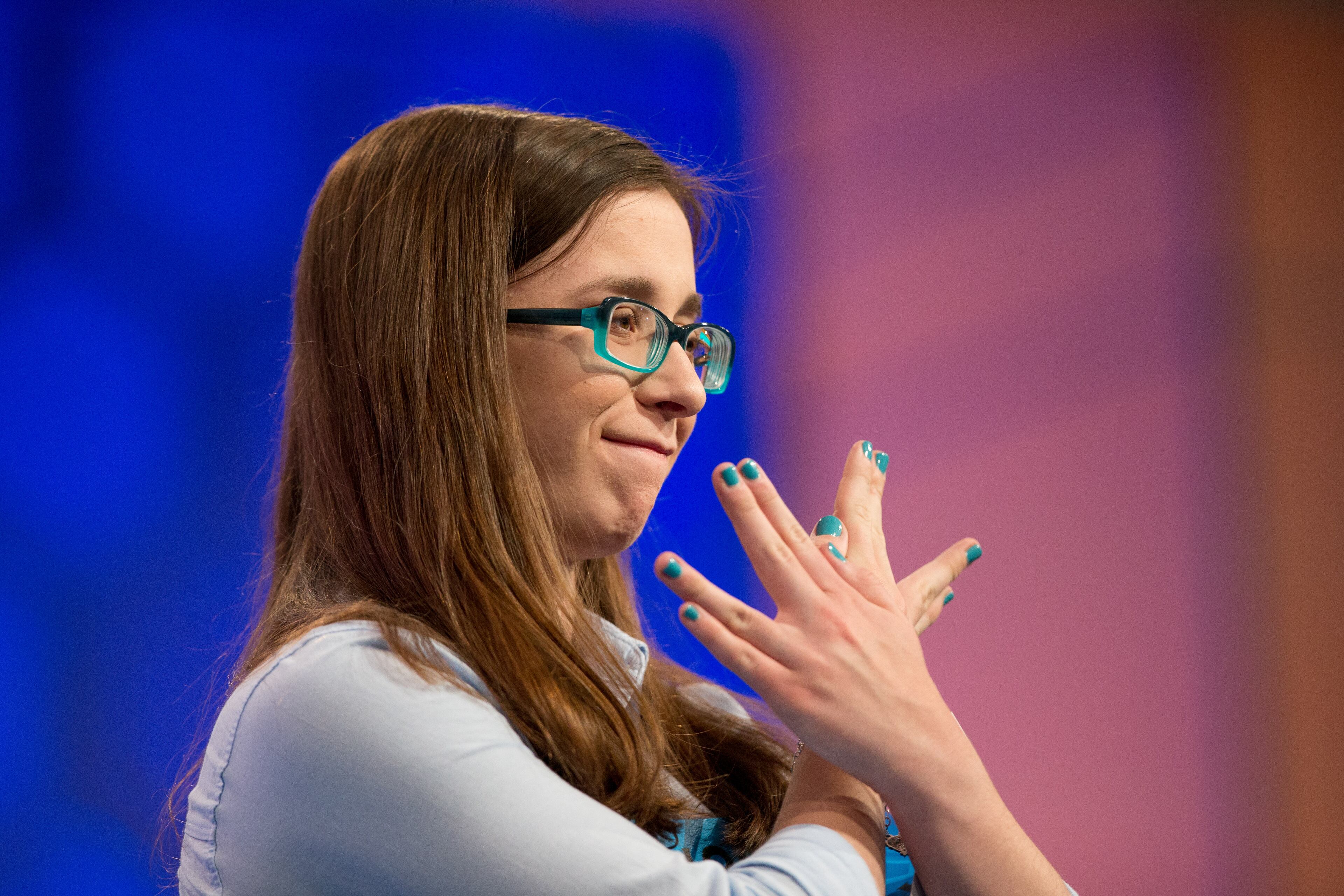 Madeline Rickert, 14, of Bismarck, N.D., gestures to the audience after correctly spelling "telamon" during the preliminaries of the Scripps National Spelling Bee, Wednesday, May 27, 2015, at National Harbor in Oxon Hill, Md. (AP Photo/Andrew Harnik)