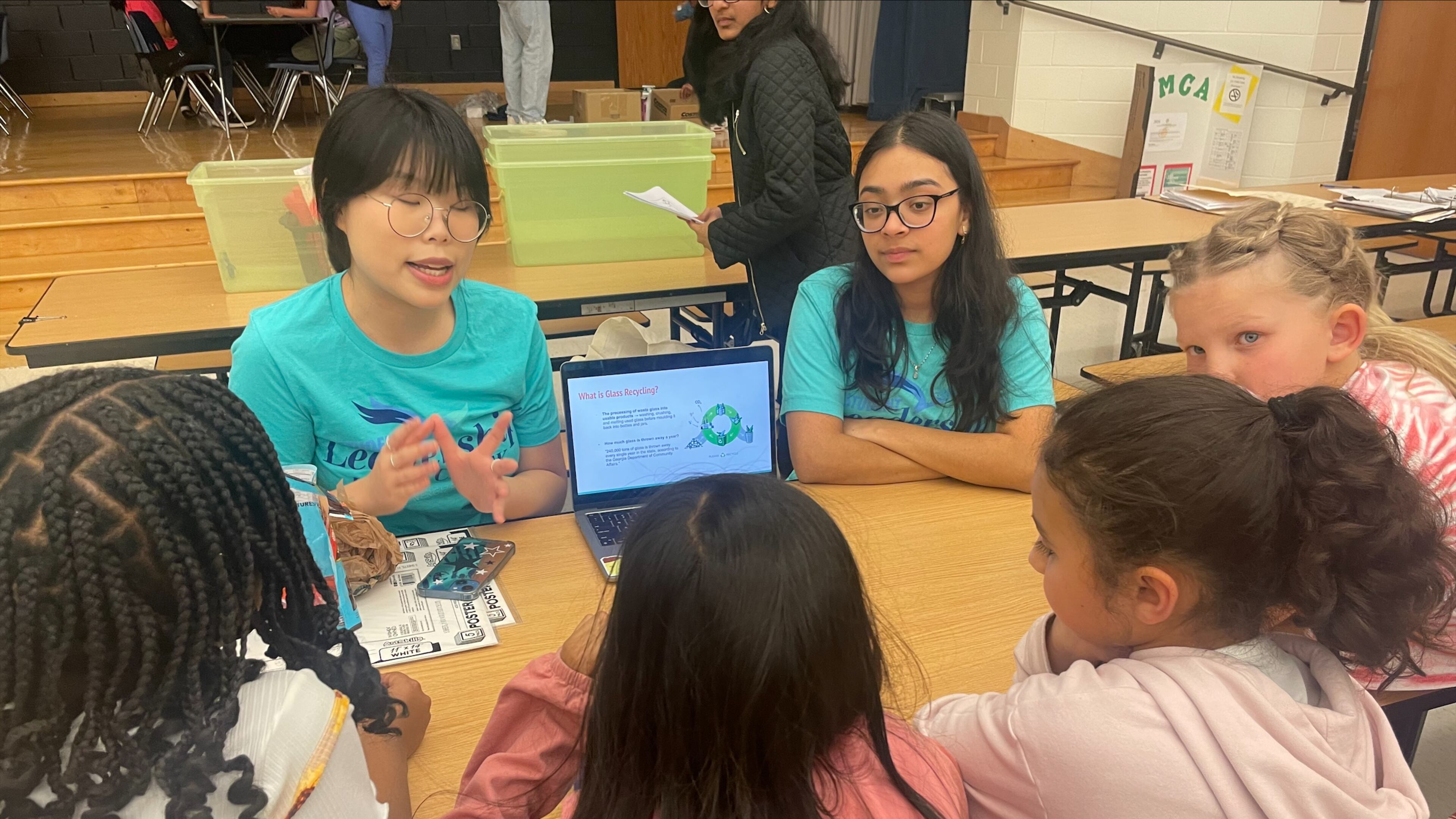 Northview High students Lydia Lee (right) and Riana Patel taught a lesson on glass recycling to Findley Oaks Elementary students. Courtesy
