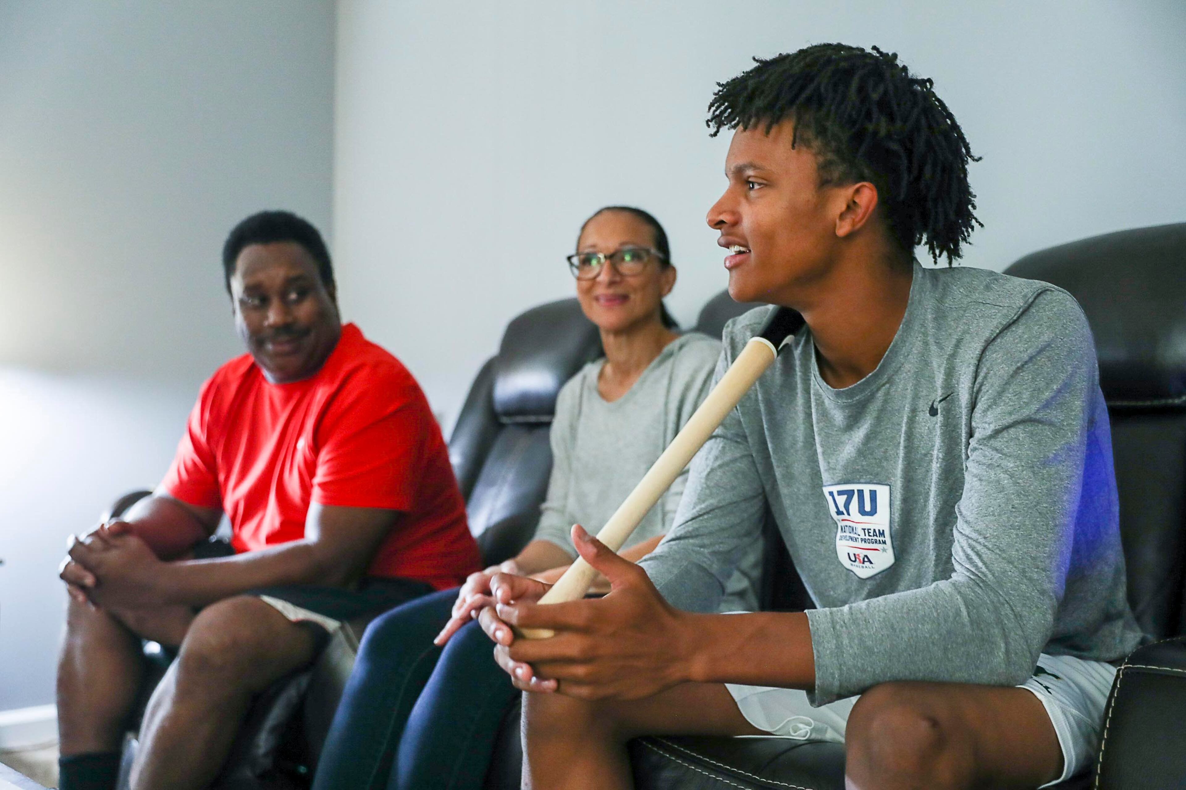 As C.J. Abrams speaks about his future at home in Alpharetta, parents, Ruth (center) and Chris (left) eavesdrop. (Alyssa Pointer/alyssa.pointer@ajc.com)
