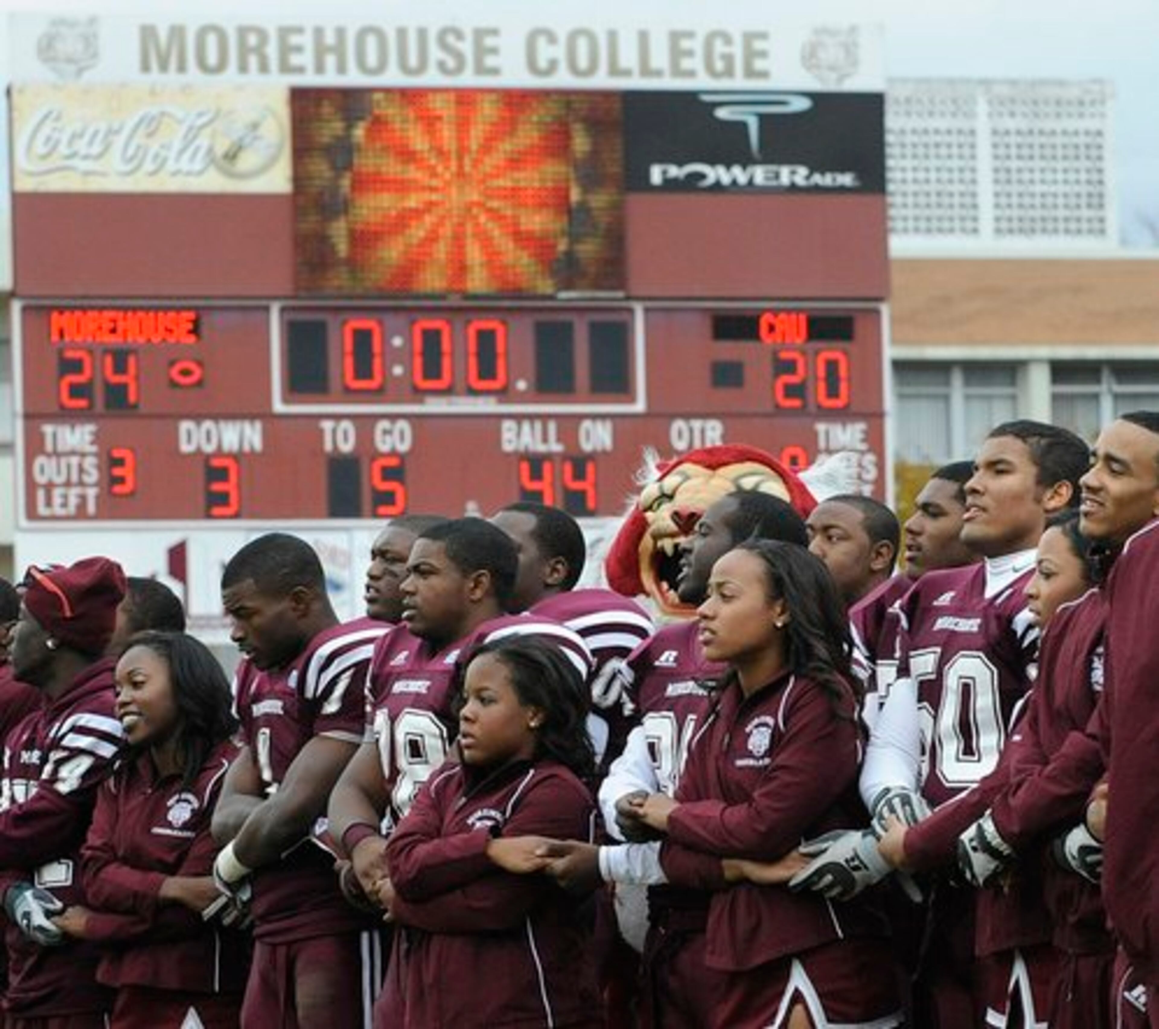 Morehouse College football players and cheerleaders join hands and sing the Morehouse school song after defeating Clark Atlanta University 24-20 on Saturday.