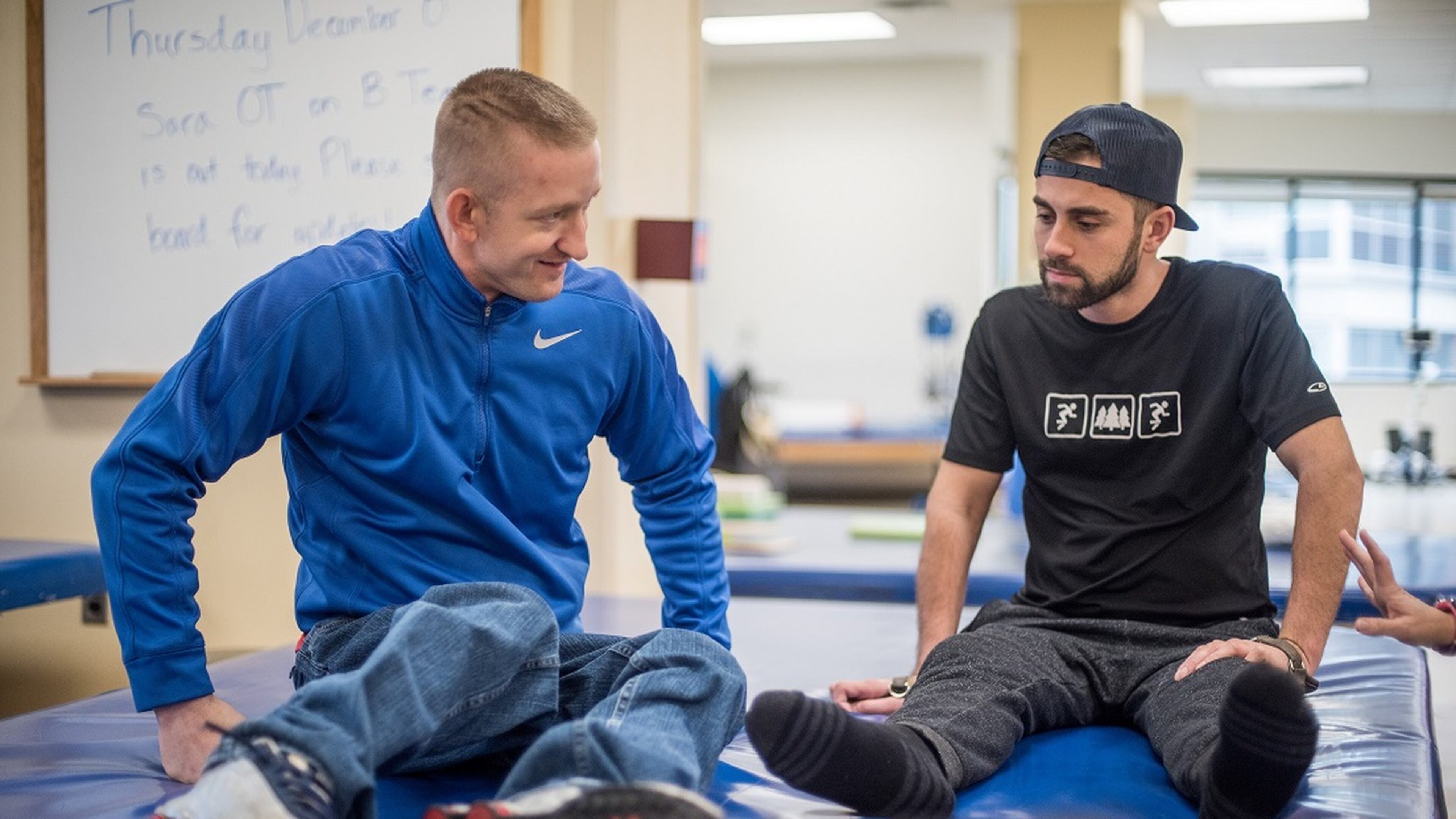 Talbot Kennedy (left) shows Shepherd Center patient George Casares some stretching exercises. LOUIE FAVORITE