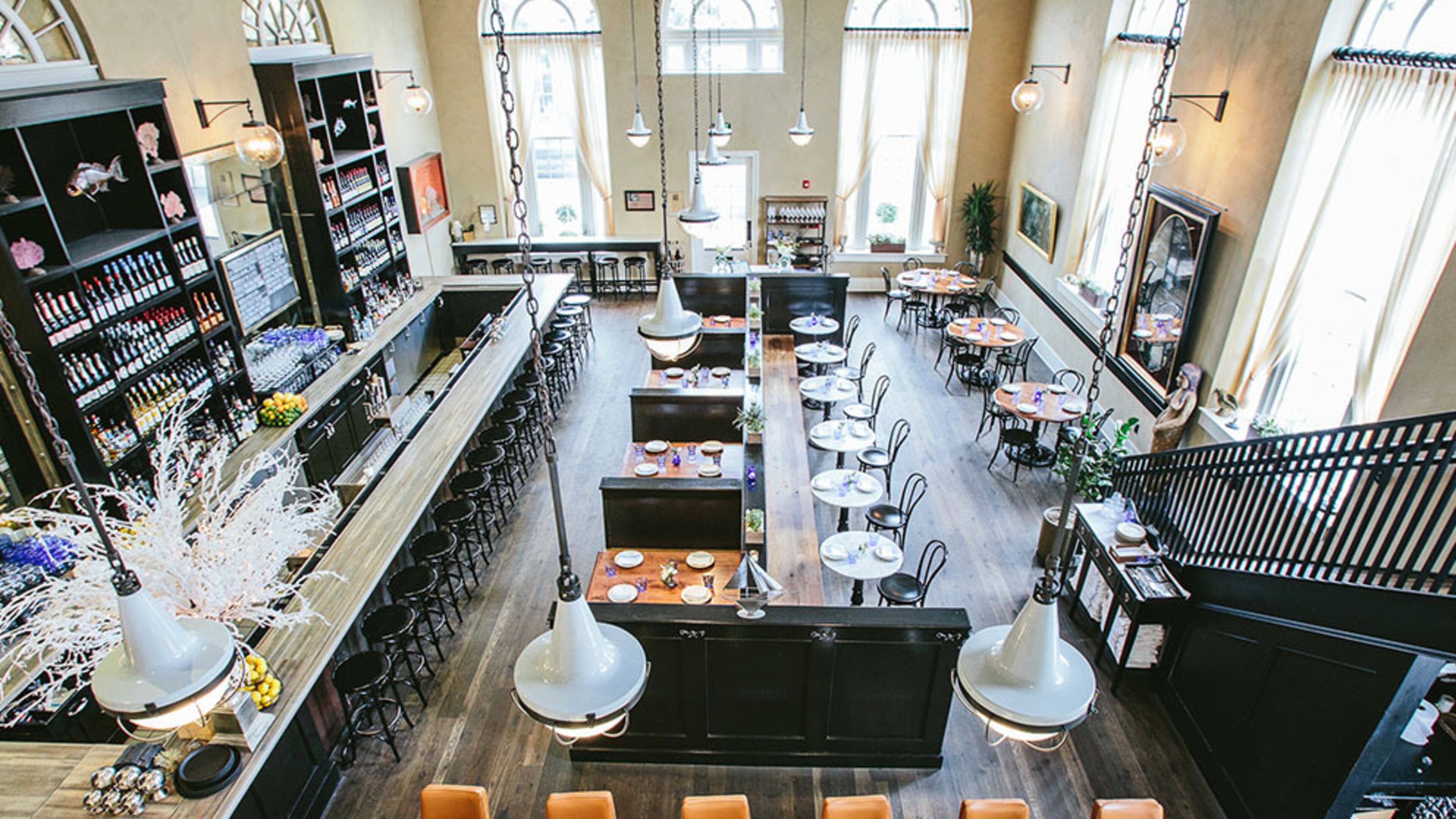 Enjoy a seafood dinner on the second floor of The Ordinary, overlooking the grand dining room and oyster raw bar.