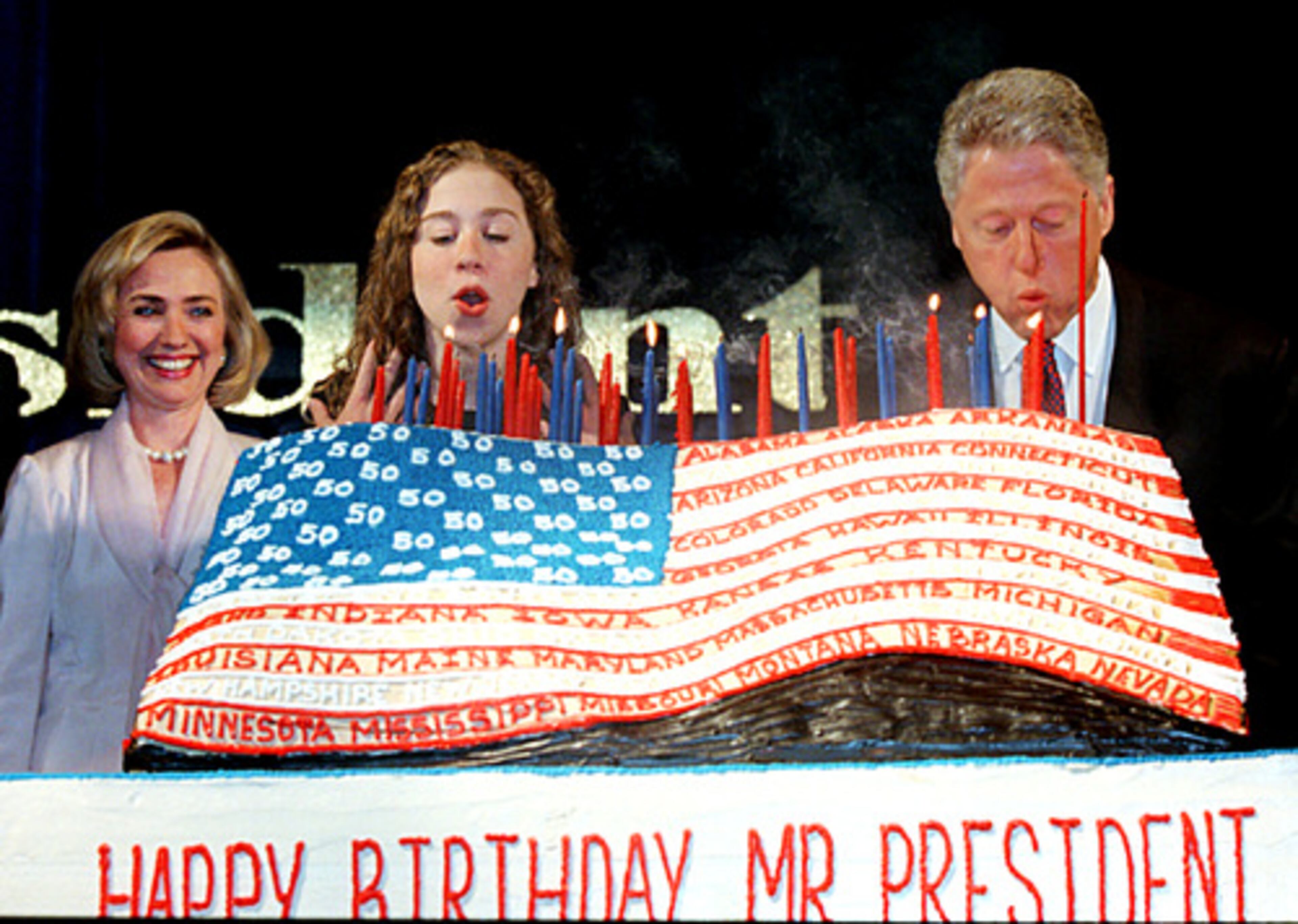 President Bill Clinton blows out the 50 candles of his birthday cake with the help of his daughter, Chelsea, center, as first lady Hillary Rodham Clinton looks on at The Sheraton New York Hotel in 1996.