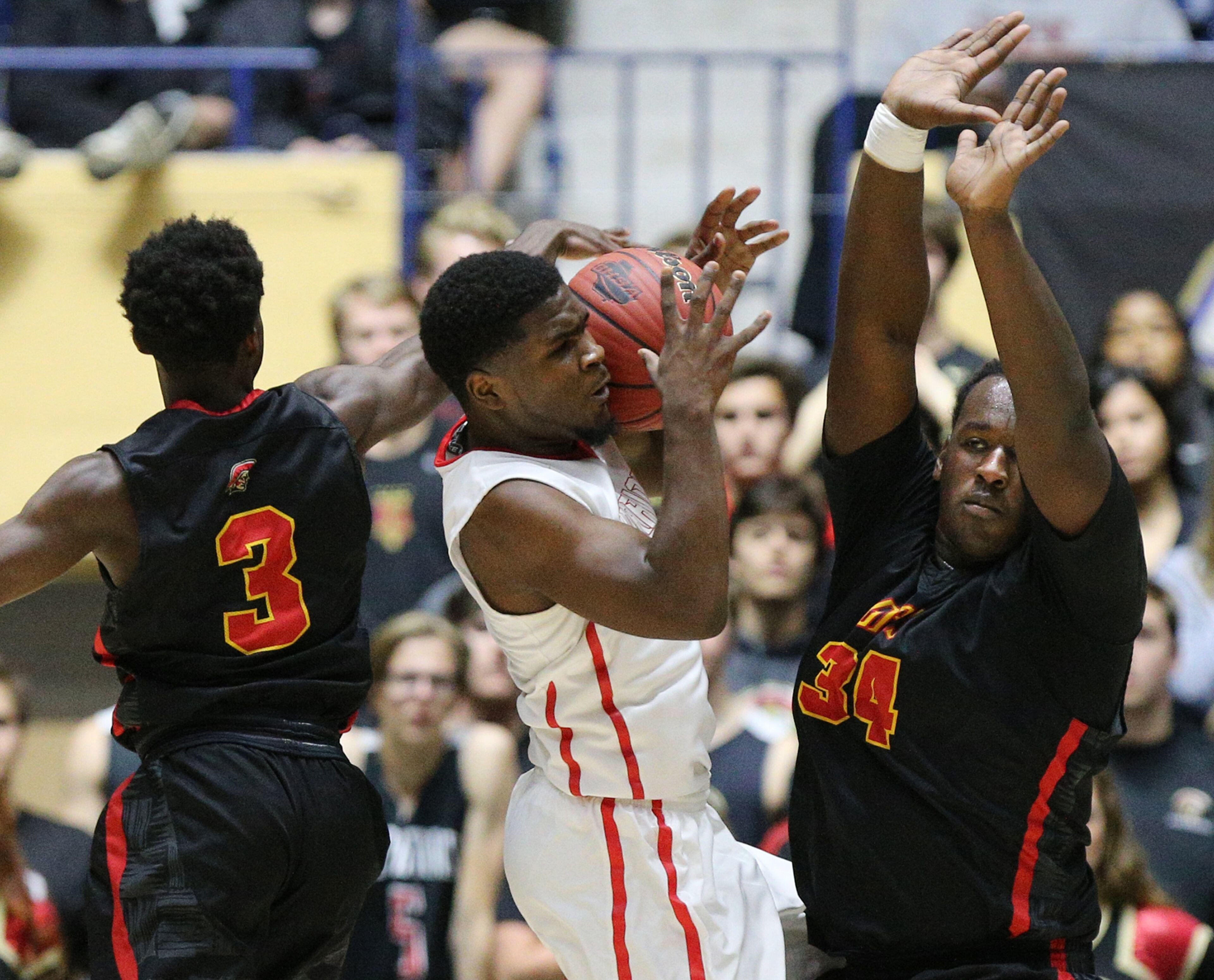 March 8, 2018 Macon: GAC defenders Roy Dixon and Chris Hinton block Jenkins guard Treâ Mays drive to the basket in their GHSA state basketball championship game on Thursday, March 8, 2018, in Macon. Curtis Compton/ccompton@ajc.com