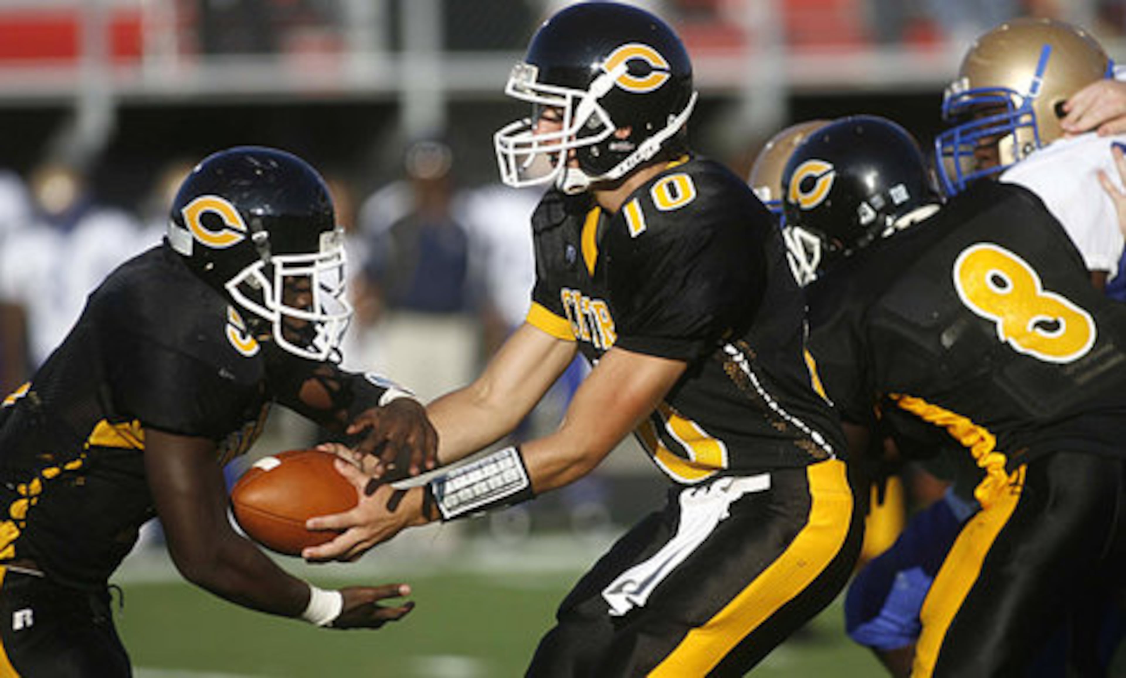 Central Gwinnett quarterback Steven Bott hands off to Ben Tayi in the first half.