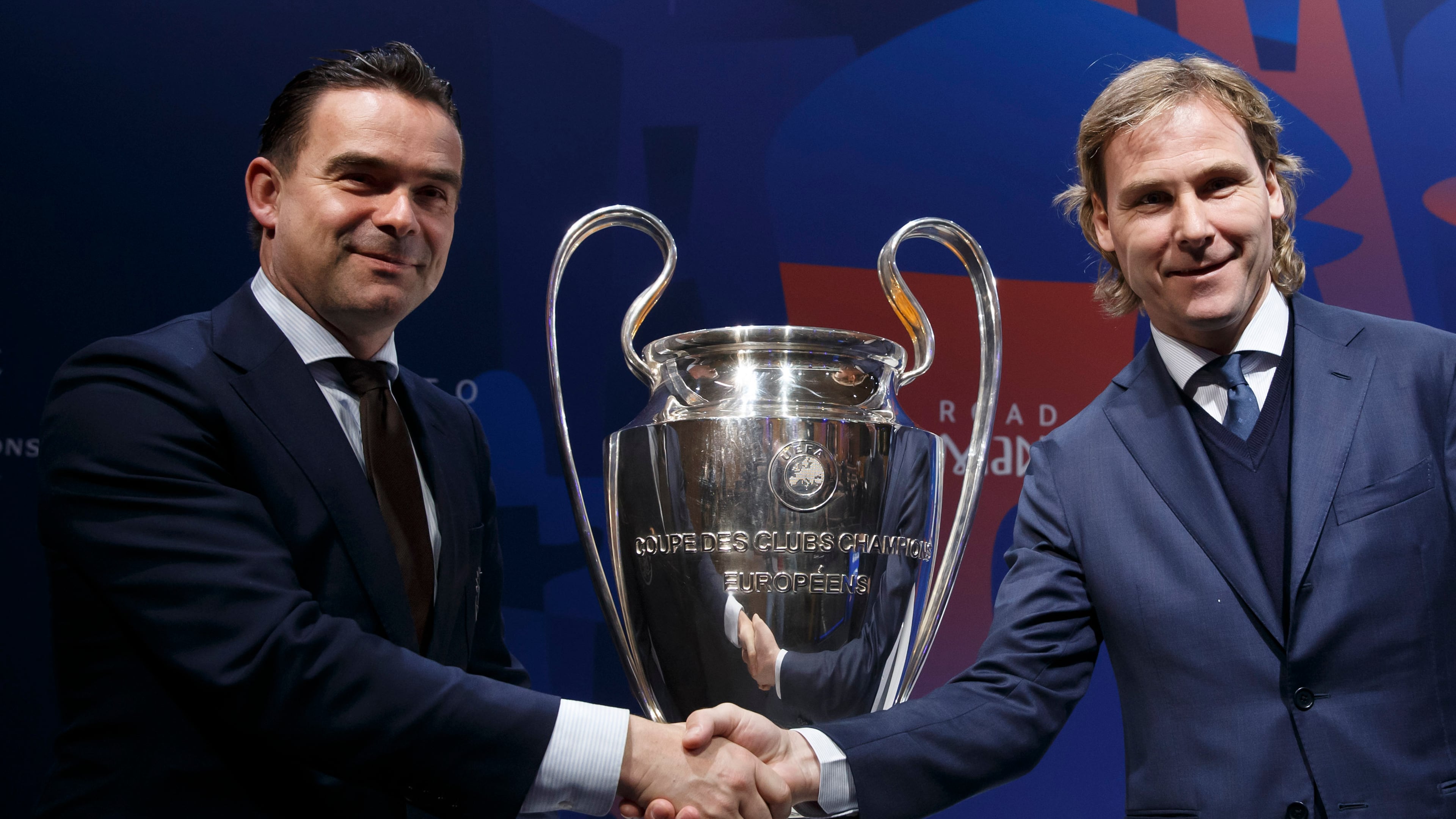 FILE - Marc Overmars, left, shakes hands with Pavel Nedved at the UEFA headquarters in Nyon, Switzerland, Friday, March 15, 2019. (Salvatore Di Nolfi/Keystone via AP, file)