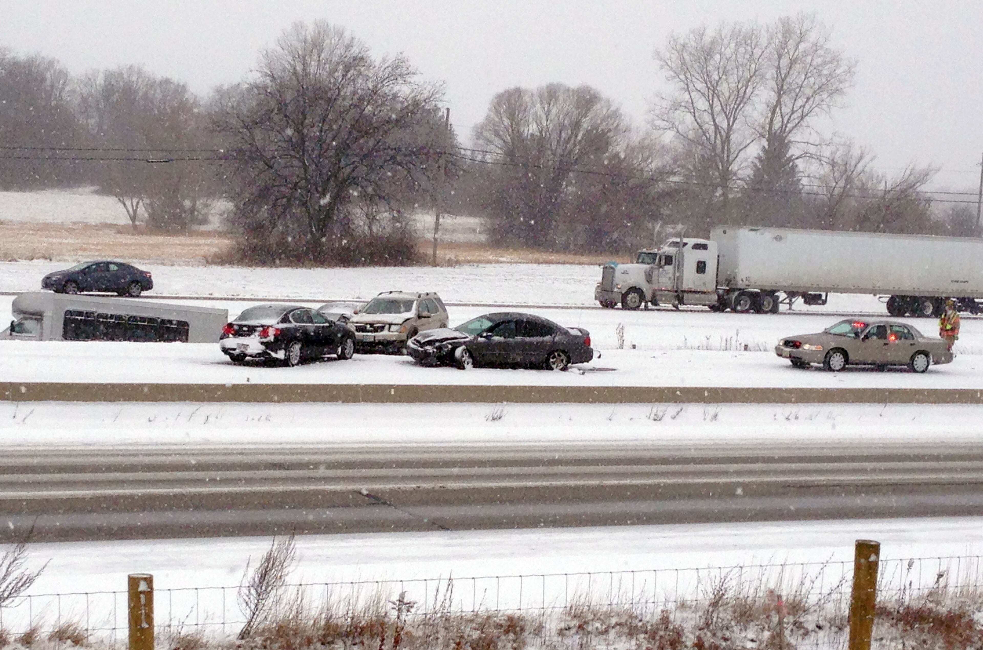 Emergency personnel respond to the scene of an accident on Interstate 94 south of Milwaukee, near Racine, Wis., on Sunday, Dec. 8, 2013. Snow is causing treacherous driving conditions in southeastern Wisconsin. Multiple accidents have been reported on Interstates 94 and 894, as well as I-39 and I-90. The Milwaukee County Sheriff's Office describes conditions as extremely dangerous and slippery, with multiple pileups, including a fatal rollover on I-94 eastbound at Highway 100.
