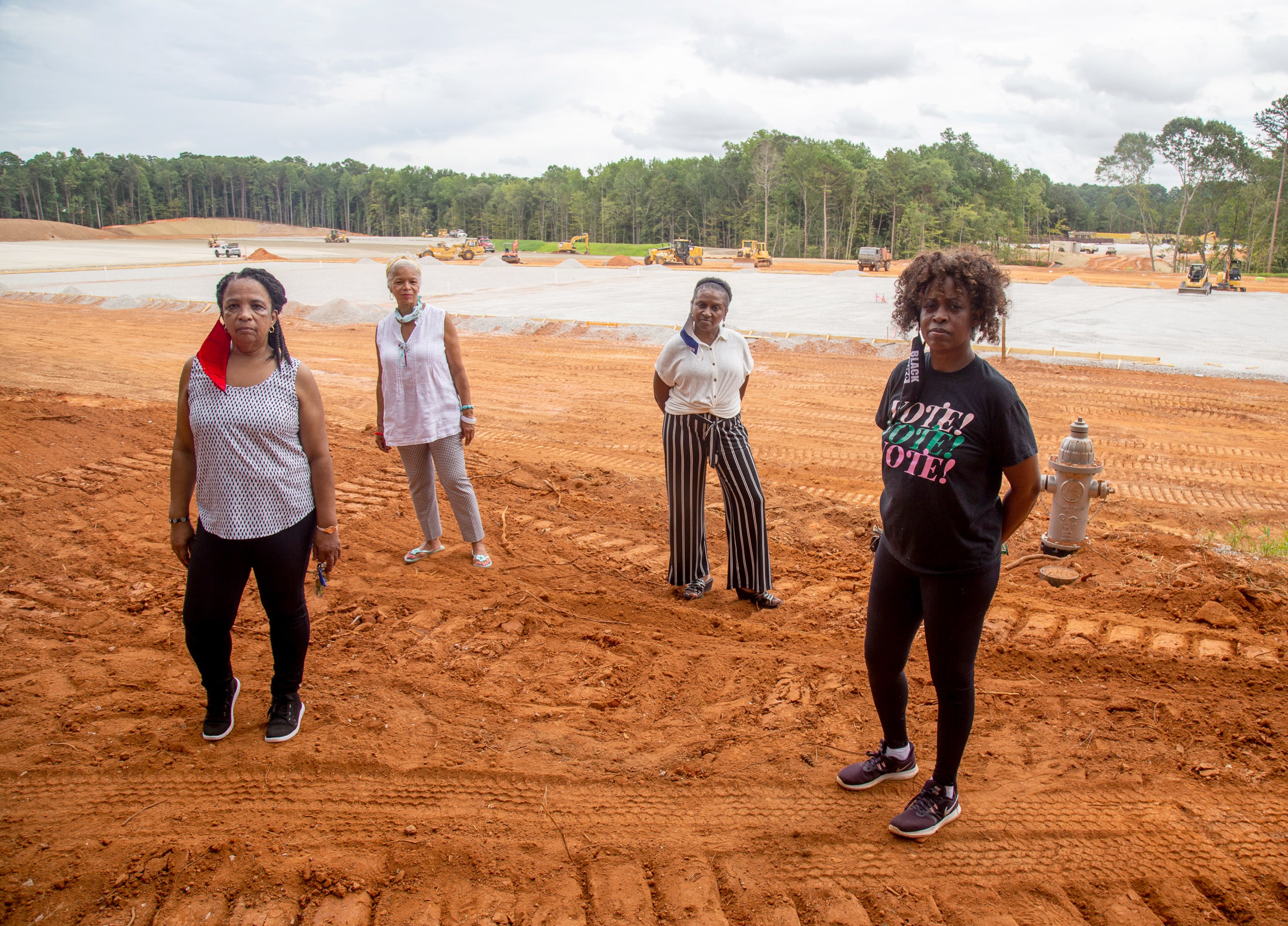 Residents of the subdivision Windsor Downs (from left) Renee Cail, Jake Bryant, Jennifer Wilson and Pyper Bunch, stand at the construction site of a recycling plant across the street from their neighborhood on Friday, July 24, 2020. (Steve Schaefer/AJC 2020)