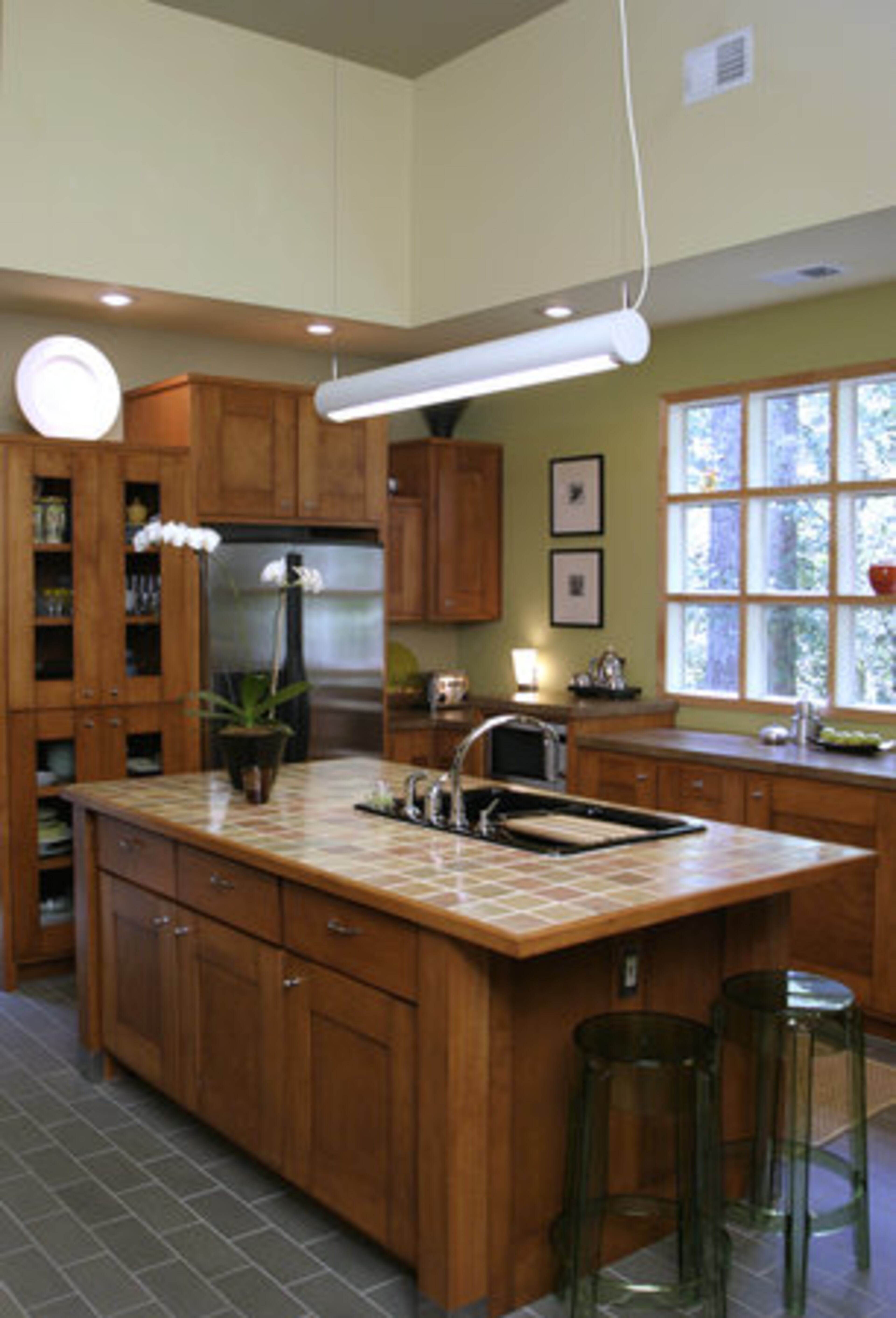 The Mills' kitchen cabinetry has a clean, simple look. Kim plans to change the counters and sink in the future.